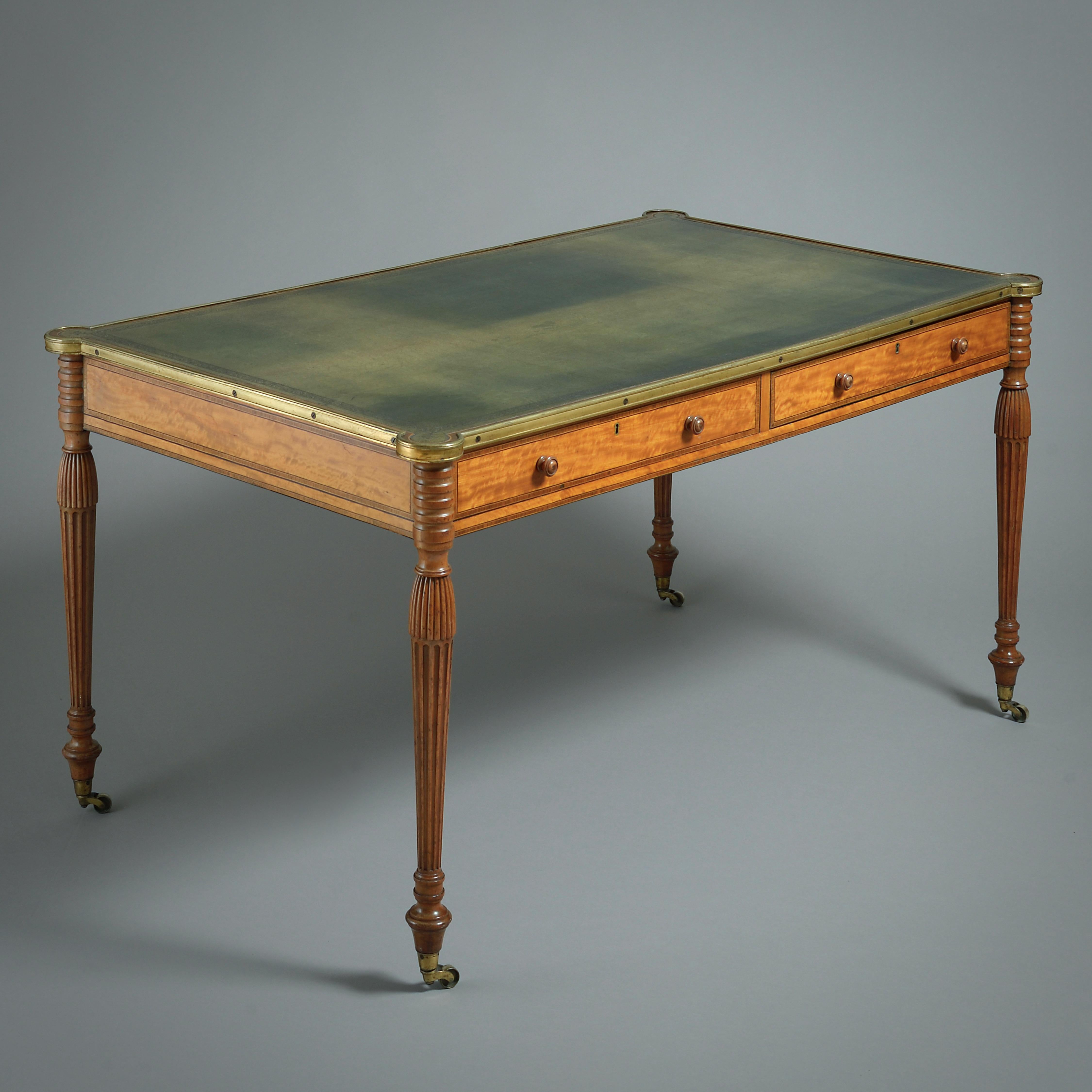 A FINE GEORGE III BRASS-MOUNTED SATINWOOD WRITING-TABLE, CIRCA 1790.

The frieze crossbanded in kingwood fitted with a cedar-lined drawer to each side.