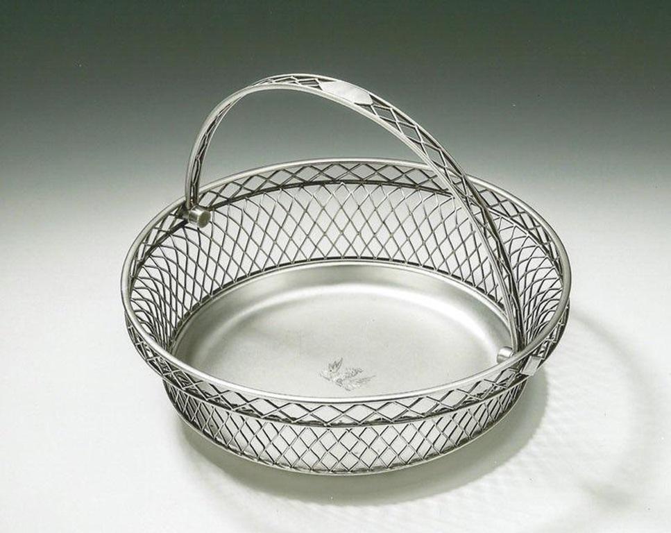 An extremely rare & unusual George III antique silver Bread Basket made in Sheffield in 1806 by Nathaniel Smith & Company.

The Basket has a solid plain stepped base which rises to very unusual diamond shaped wire work sides. The swing handle is