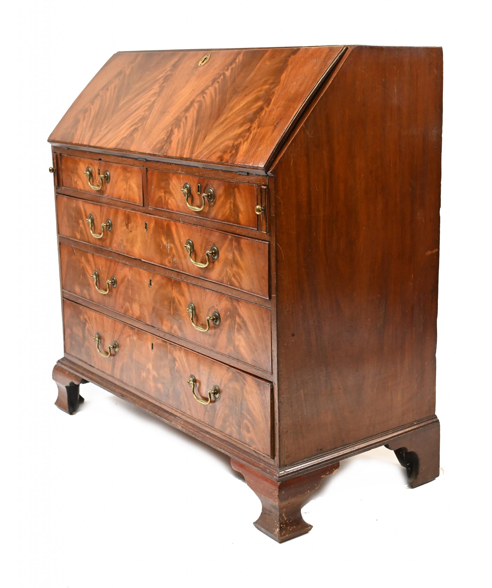 Gorgeous George III bureau with original brass handles
Stands on oggee bracket feet with fitted interior
Top opens out to reveal green felt writing surface surrounded by drawers and cubby holes
Great patina to the flame mahogany
Circa 1790 on