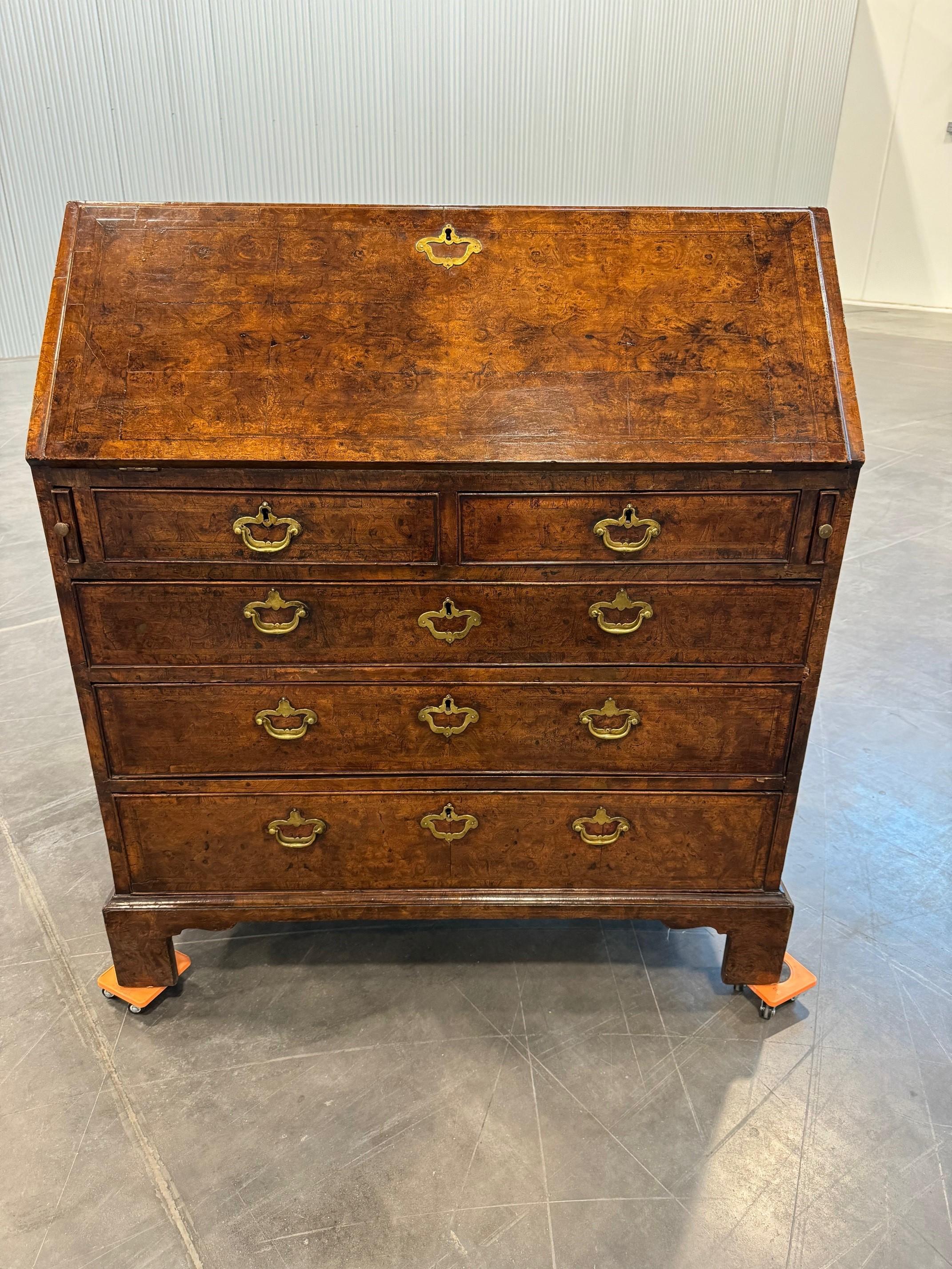 
An absolutely wonderful example of a Georgian bureau with exceptional coloring and a fall front revealing a red leather writing interior, with pigeon holes, drawers, cupboard and bible ends. All above 2 short over three long drawers and standing on