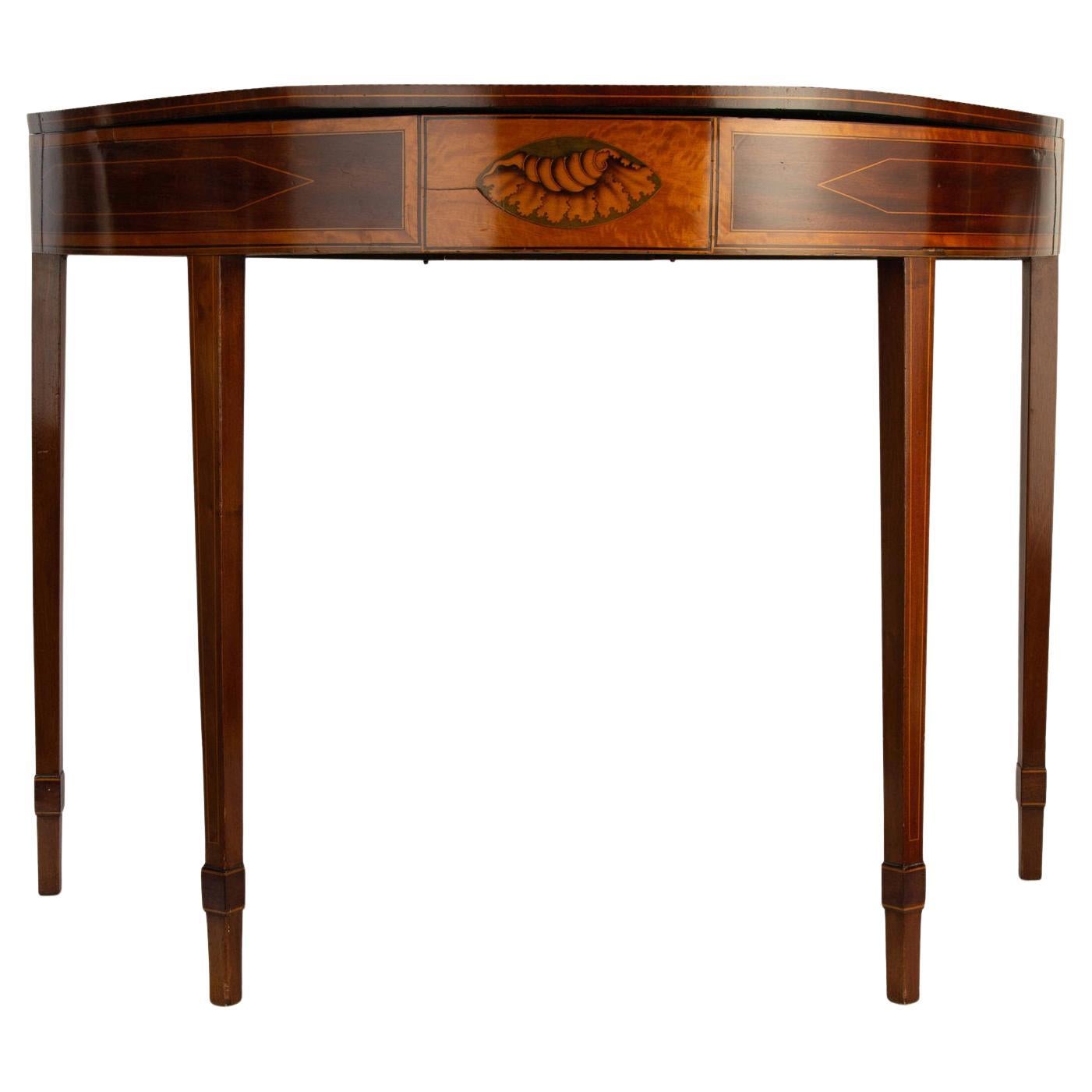 This stylish George III card table dates to the early 19th century and was acquired from an Albany, NY estate. The piece is detailed with inlaid marquetry and a cartouche of a shell. 

Note: When table is opened the height is 29.50