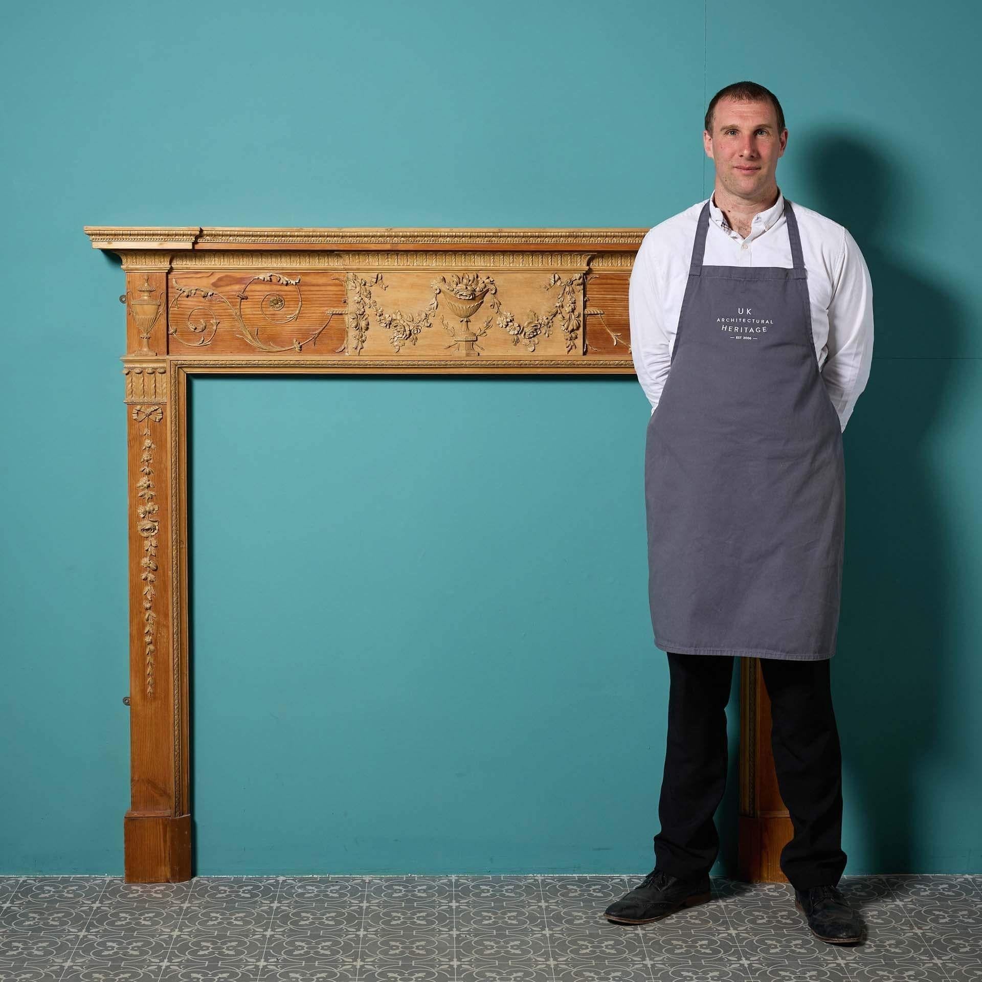 A beautiful George III carved pine fire surround in the Adam style. Dating from between 1760 and 1780, this antique fireplace was removed from a private residence in Harrogate. It is a superb example of original Georgian design, the pine structure
