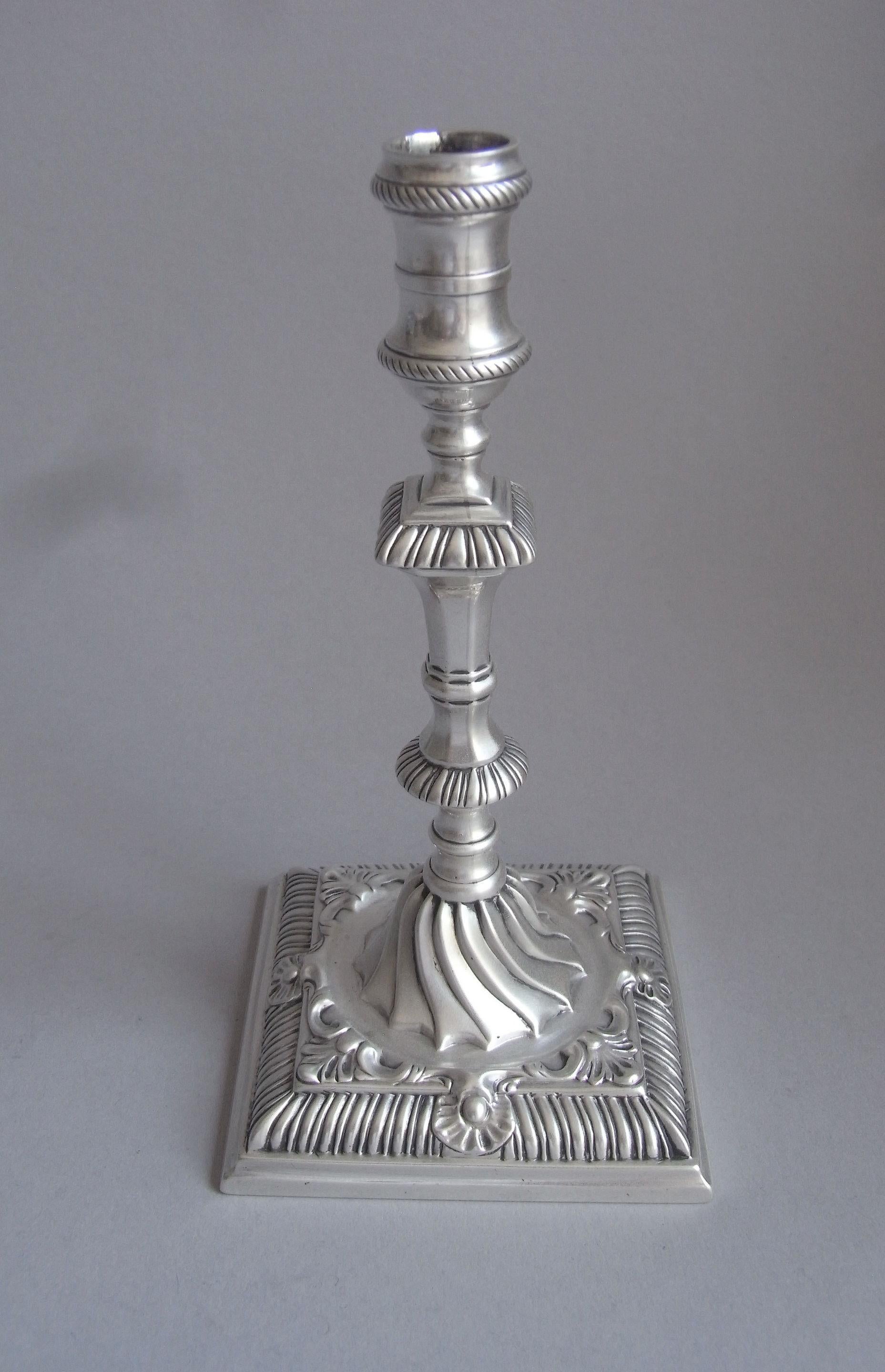 A very unusual early George III Cast Taperstick made in London in 1763 by Ebenezer Coker.

The Taperstick stands on a square base decorated with gadrooning, raying shells, scrollwork and stylised leafage, all below a very unusual domed section of