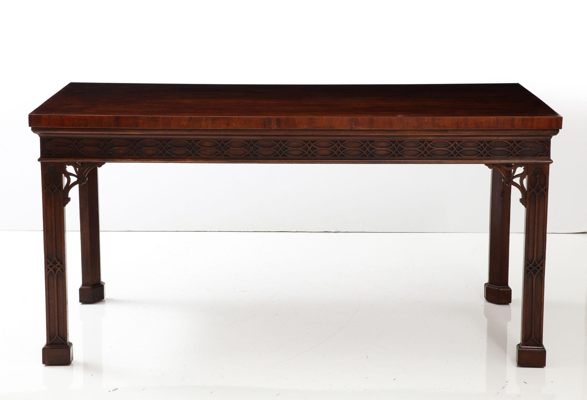 Very fine George III mahogany Chinese Chippendale console/serving table, the richly patinated top over blind fretwork carved apron and legs, joined by open fretted brackets and standing on blocked feet, the whole with good rich color and timber.