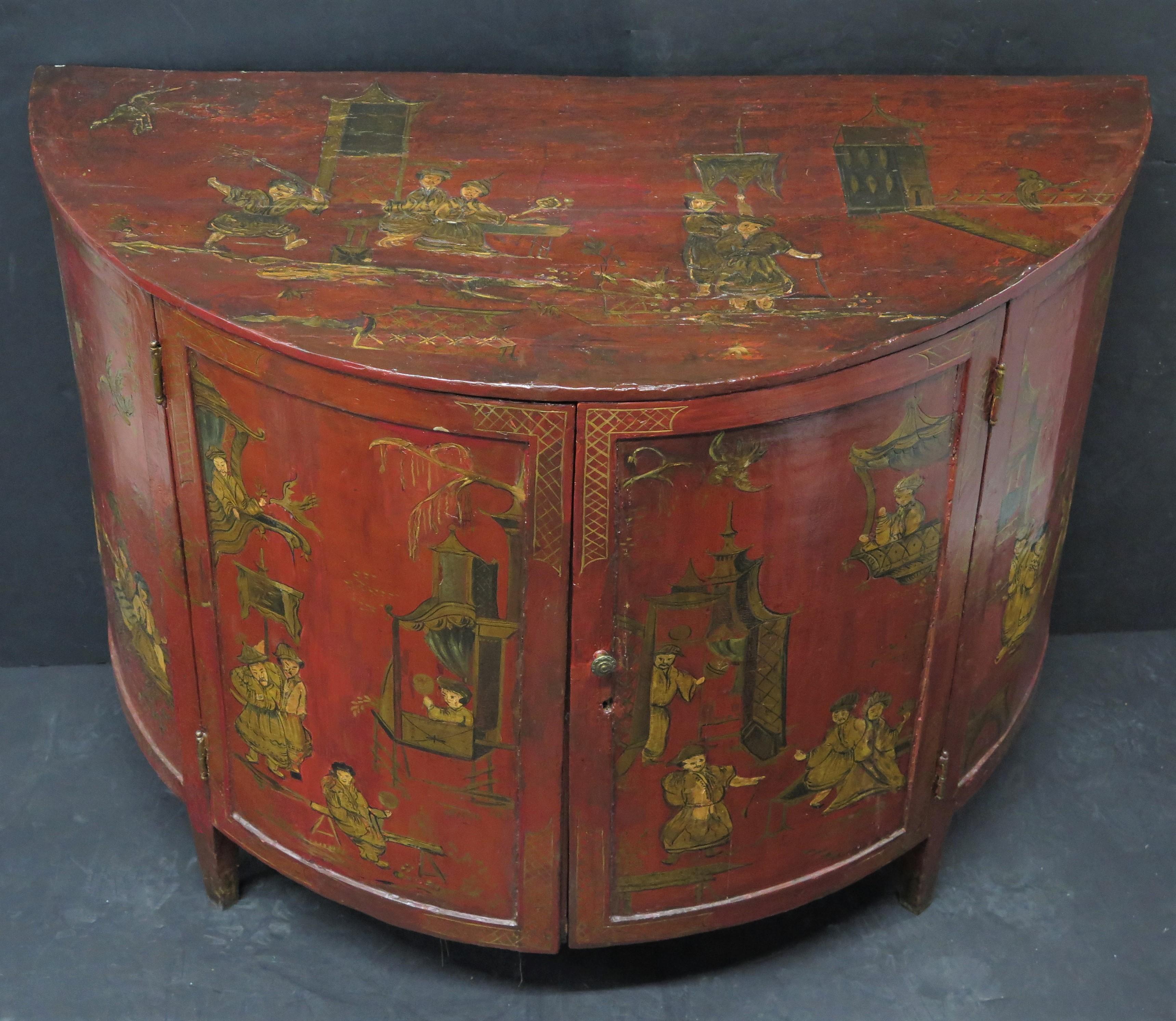 George III red laquered Chinoiserie demilune cabinet with hardwood applique and handpainting throughout, the whole stands on tapered feet, interior has one shelf and fabric throughout, England, 18th century