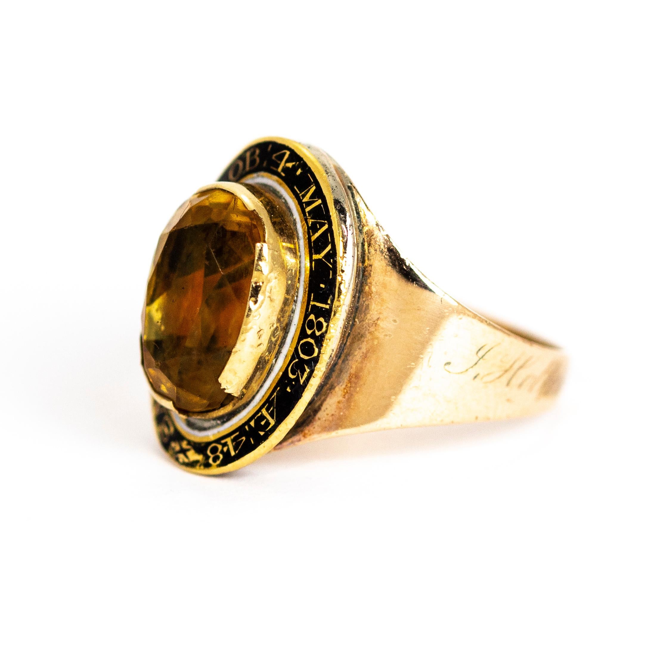 This memorial ring is rather interesting, it has three names on it to be remembered. Around the Citrine inscribed is 