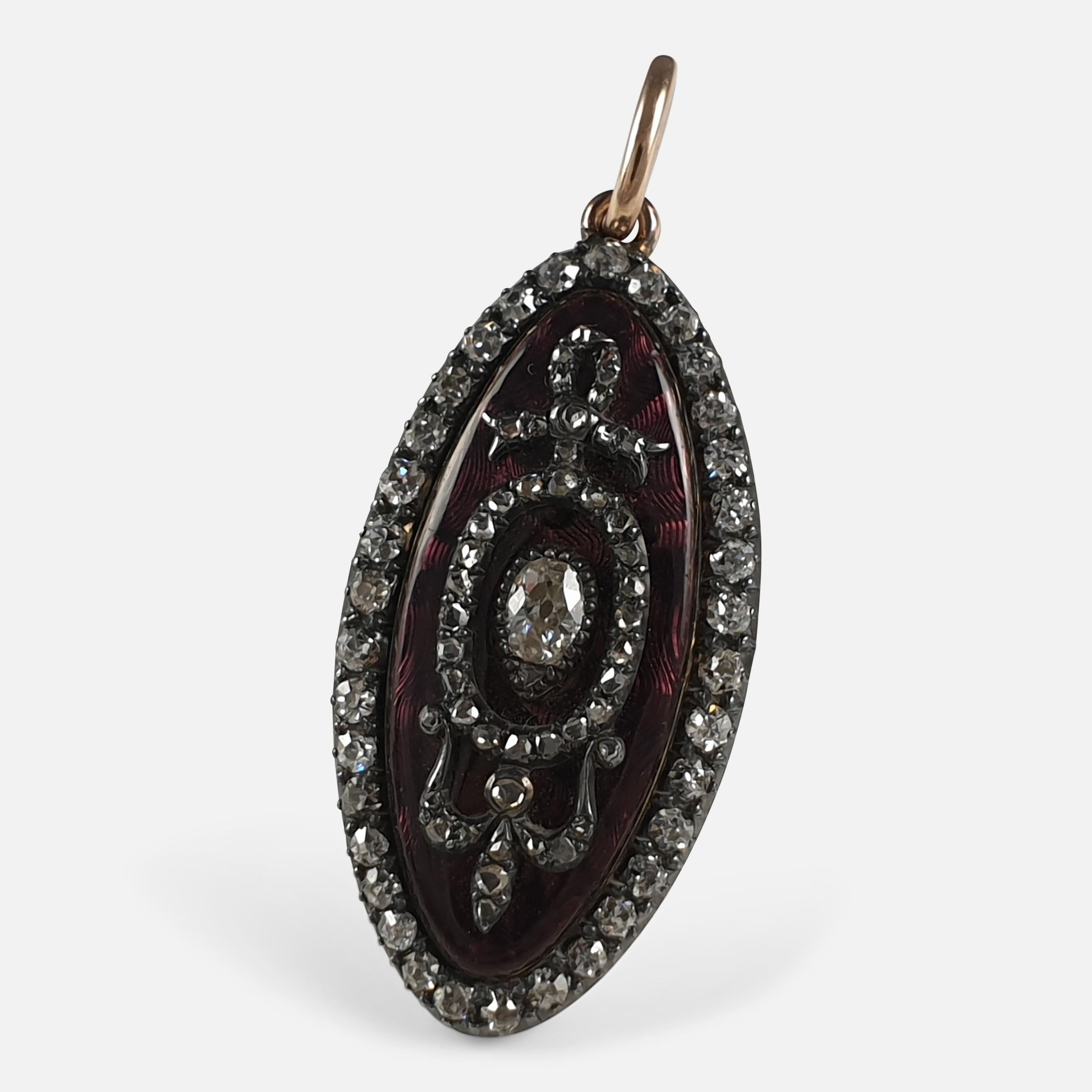 A George III diamond and enamel navette-shaped sentimental pendant, circa 1790. The pendant has been executed in the French manner, having an old cut diamond border, leading to a purple guilloche enameled ground, with a pear shaped old-cut diamond