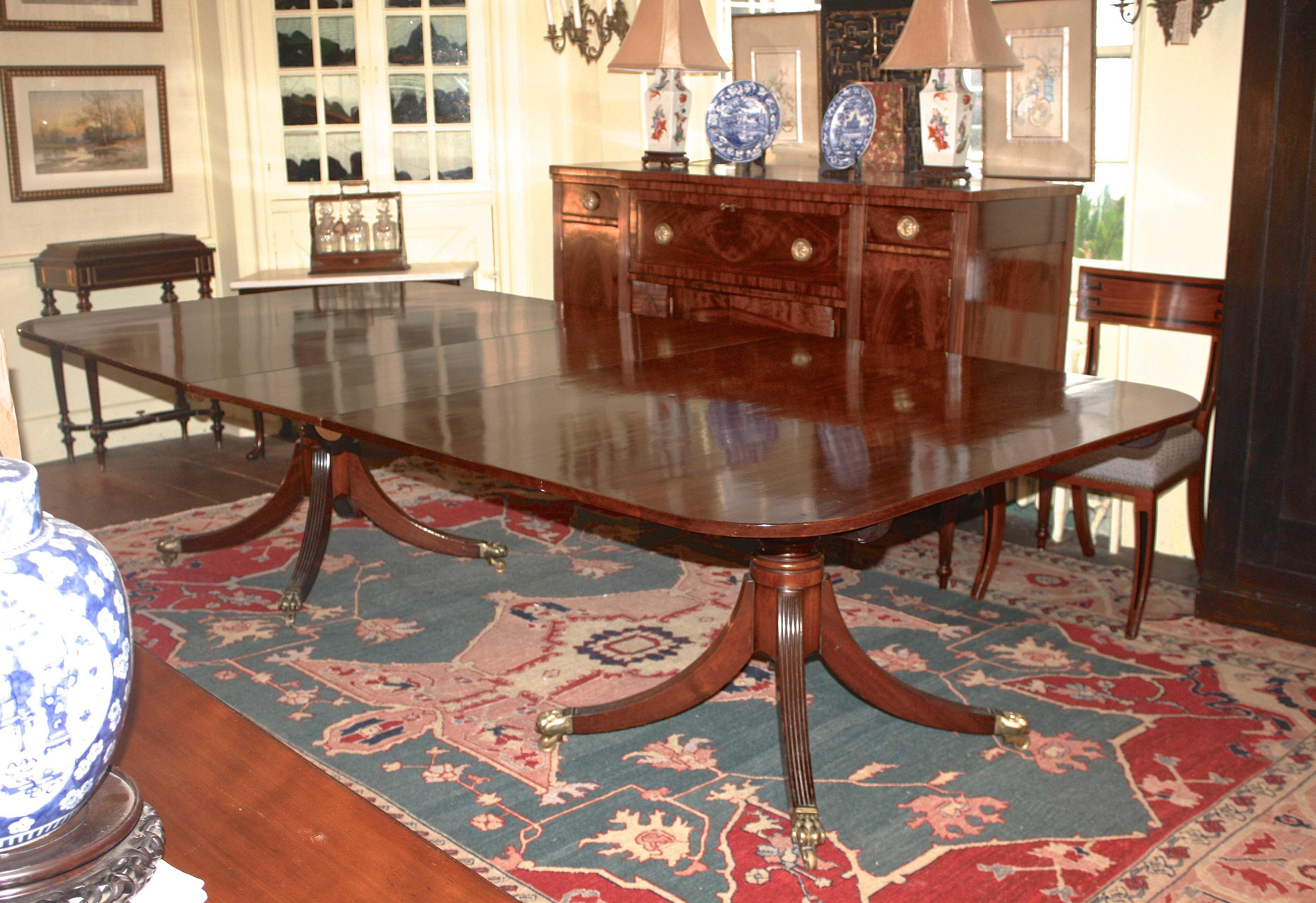 A rectangular honey-colored mahogany two pedestal dining table, comfortably seating ten with its 21.5