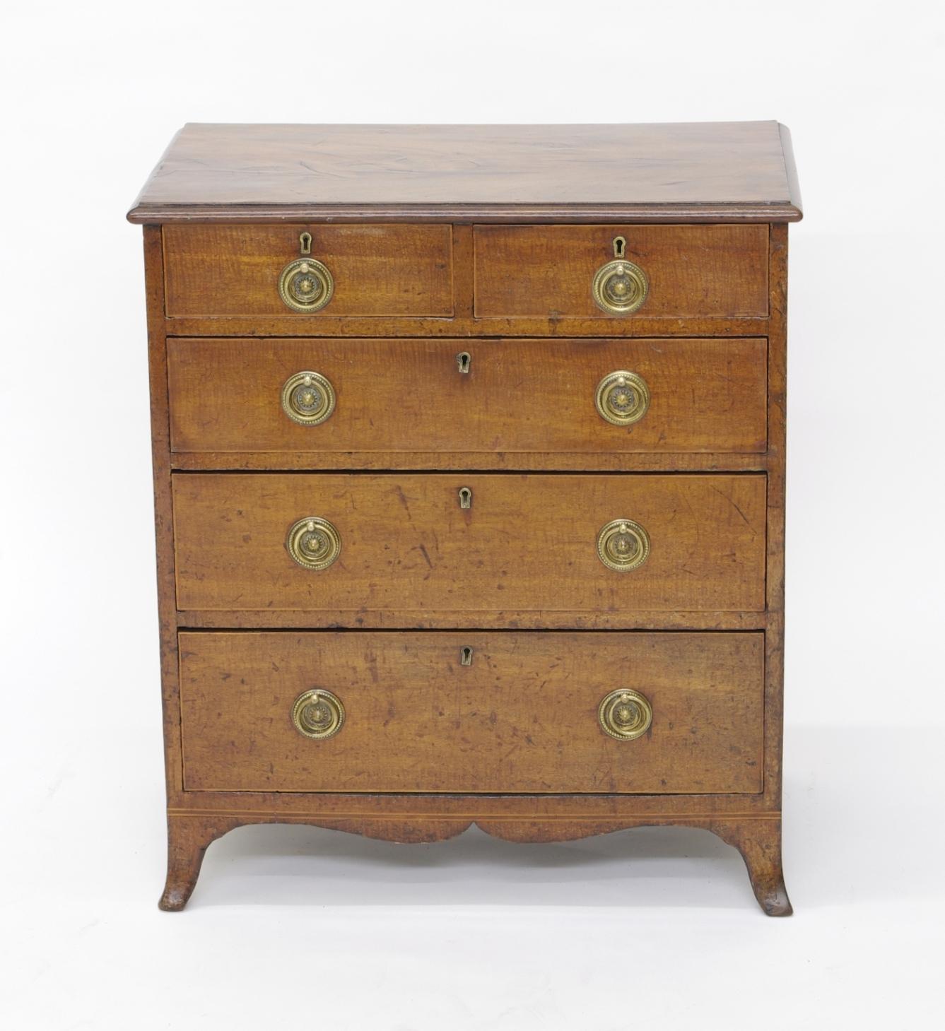 George III fiddleback mahogany small chest of drawers, the rectangular top with well figured veneer and molded edge over two short drawers and three long drawers, each with boxwood stringing and the original ring-pull hardware; the splayed legs