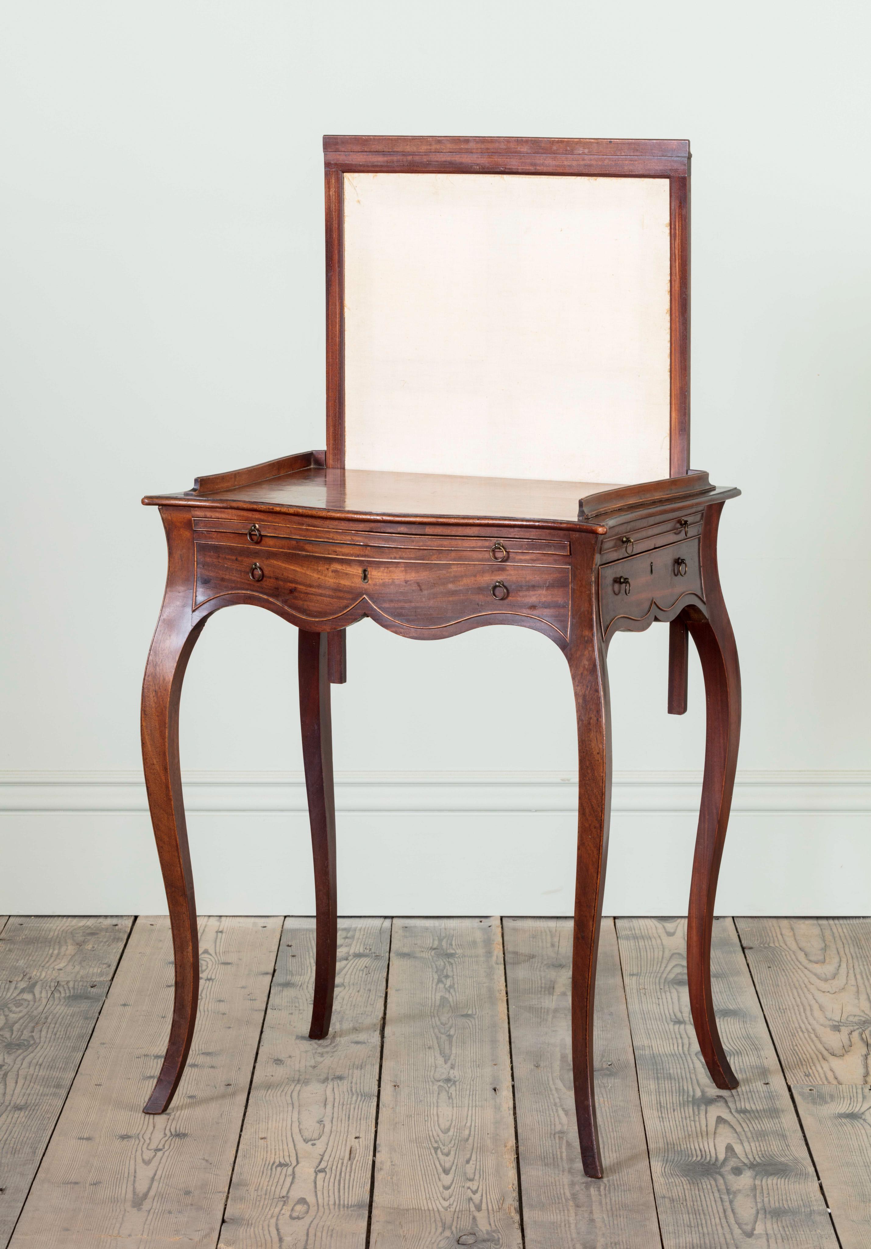 A George III figures mahogany ladies writing table, attributable to John Cobb with rising screen and concealed drawer on shaped slender cabriole legs, English, circa 1770.