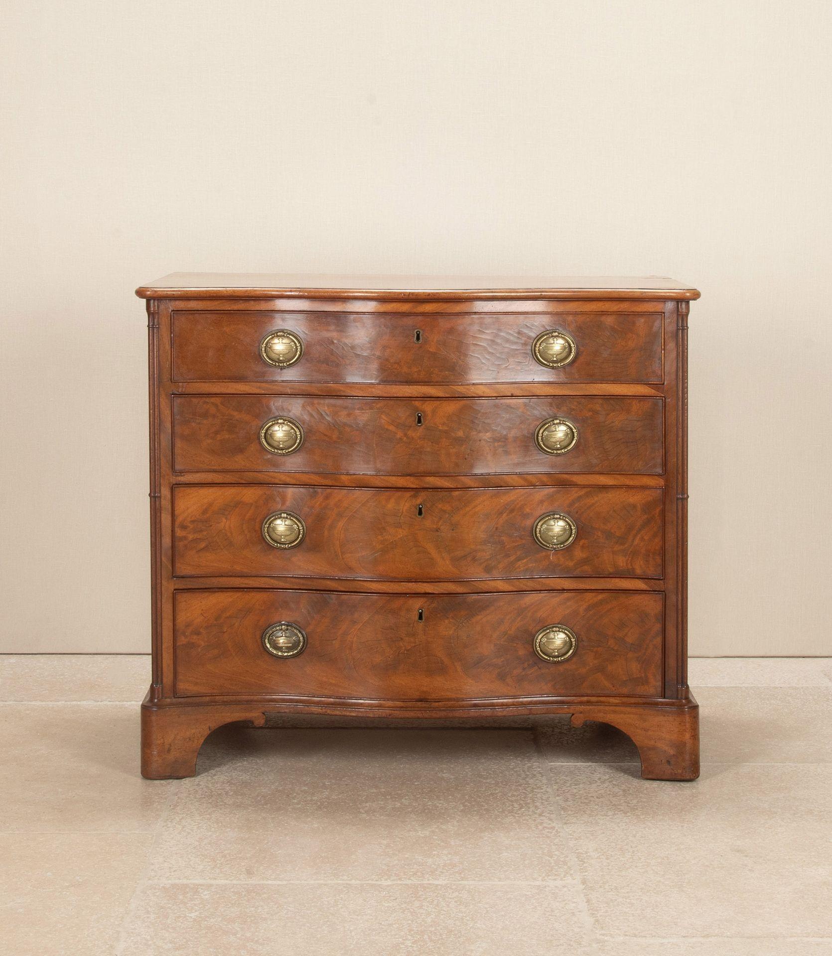 A good example of a George III chest of drawers. In figured mahogany with a lovely serpentine shaped front. With decorative canted corners and a good patina. Having four drawers, the top one was originally partitioned but has subsequently been