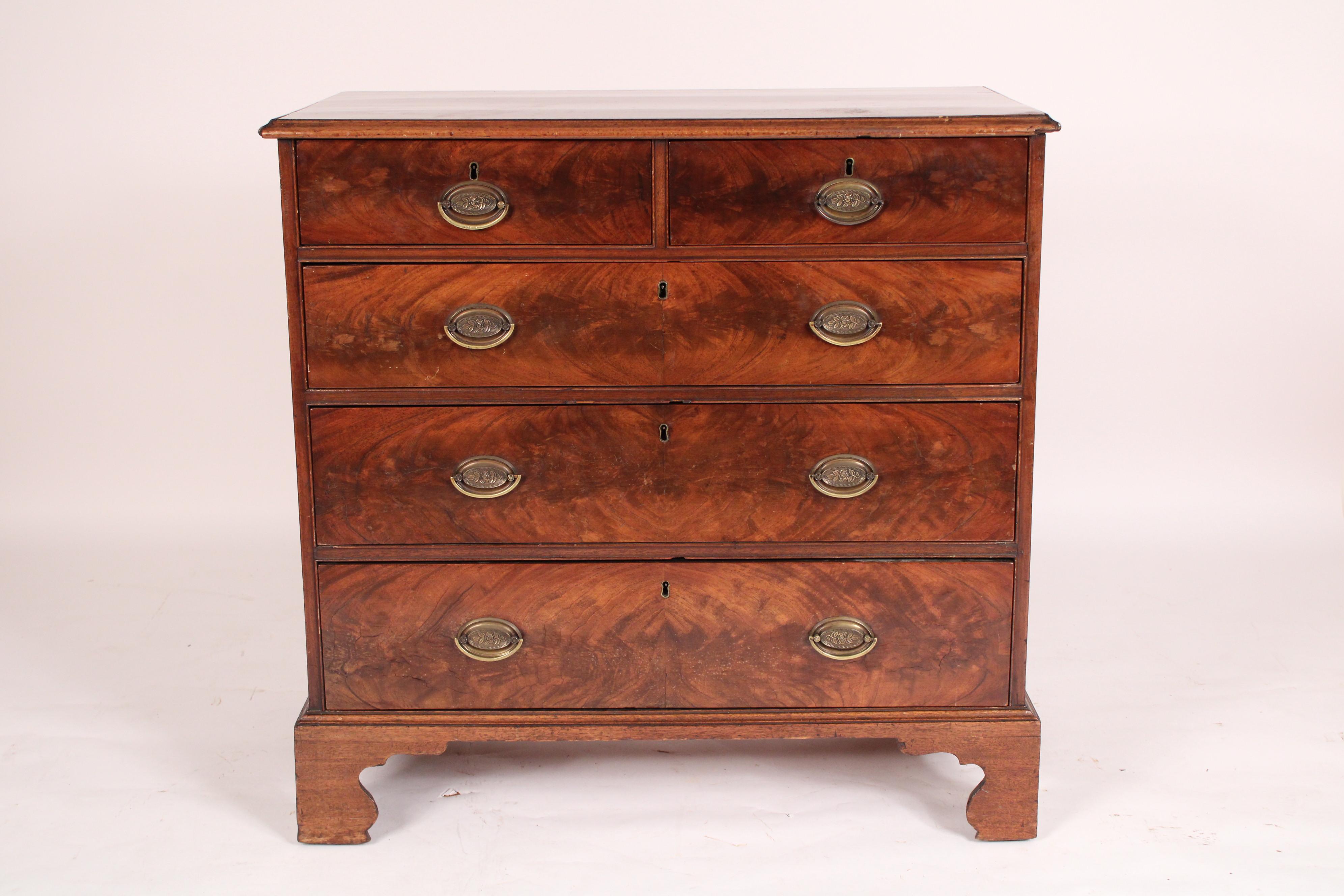 George III flame mahogany and mahogany chest of drawers, circa 1800. With a single board mahogany top with thumb molded front and side edges, two flame mahogany top drawers above 3 flame mahogany graduated bottom drawers, single board mahogany