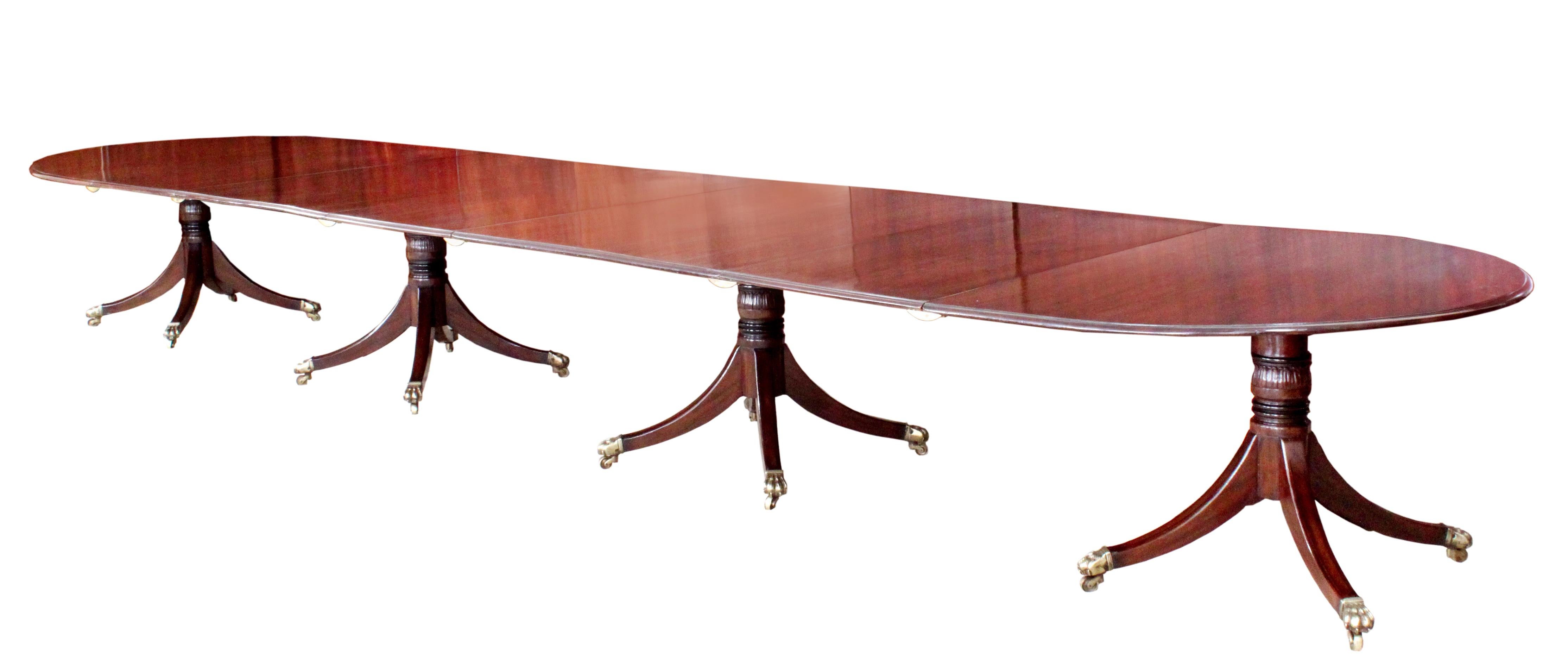 A good George III four-pedestal dining table; all four pedestals, blocks, bearers and their tops are original; the three loose leaves replaced in well matched Georgian timber. The attractive four splay bases with finely carved stems, ebonized