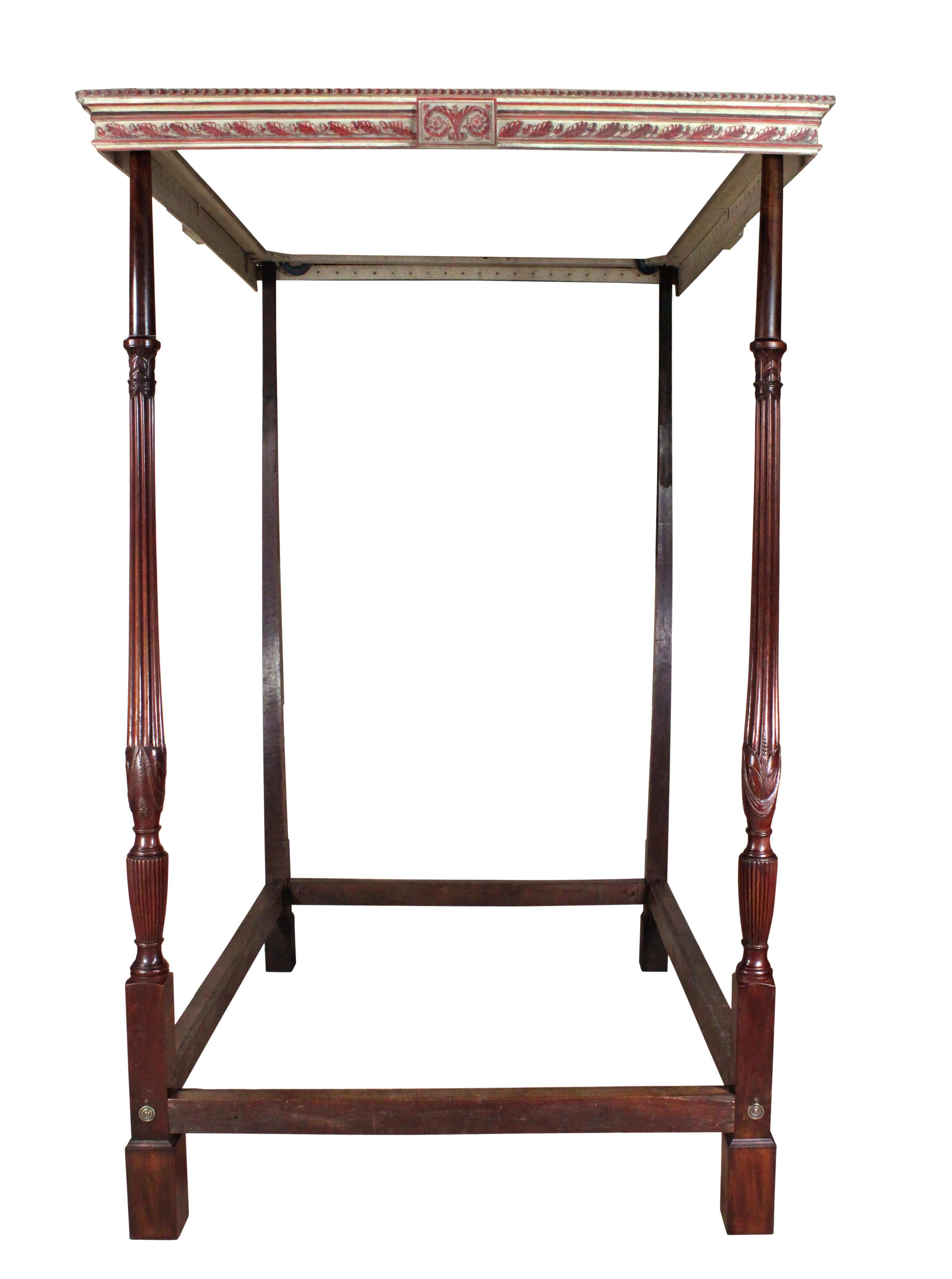 A George III four poster bed with mahogany end posts finely carved with wheat sheaves and drapery, painted cornice in attractive Etruscan colours and oak head posts and oak rails.
The bed including the cornice is largely original but the posts have