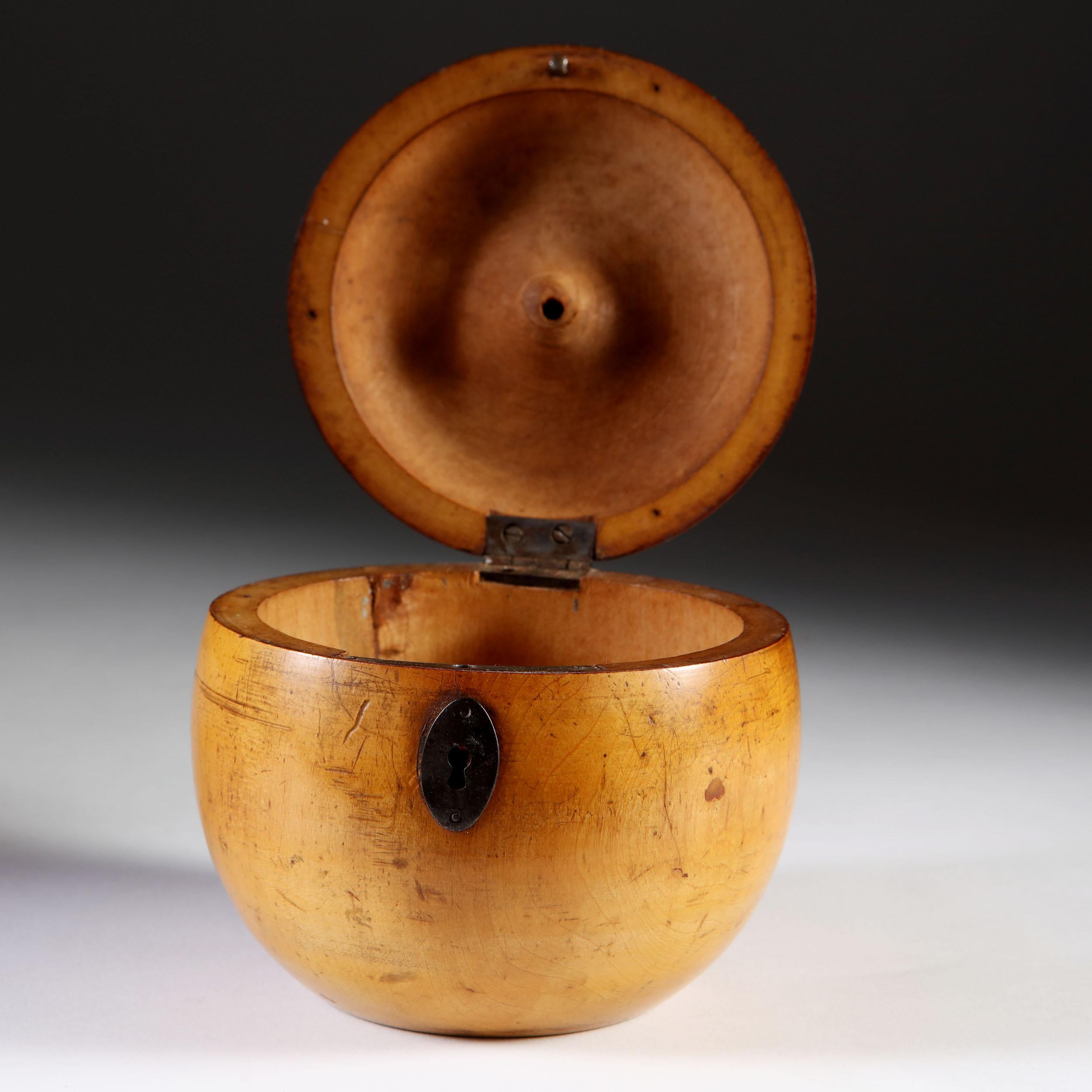 A fine late 18th century novelty fruitwood tea caddy in the form of an apple. Lathe turned and with a soft honey patina, retaining its original stalk and red paper base and remains of the original metal foil lining.
Restoration to the lid at the