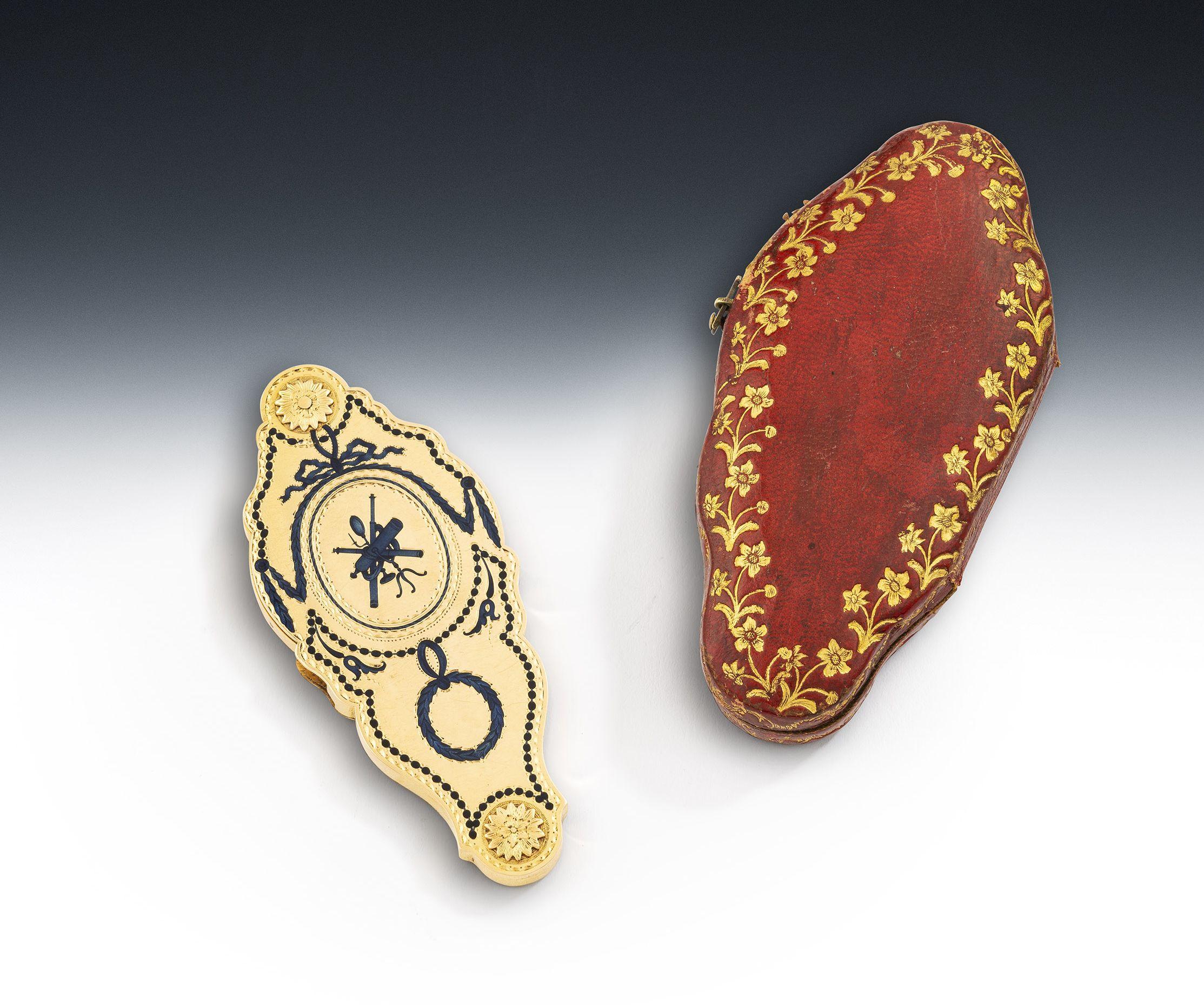 An important, and extremely rare, early George III Gold & Enamel Magnifying Glass, with original red leather case. Made almost certainly in London circa 1770.

The Gold case is of shaped rectangular form, with bright cut borders and raised, chased,