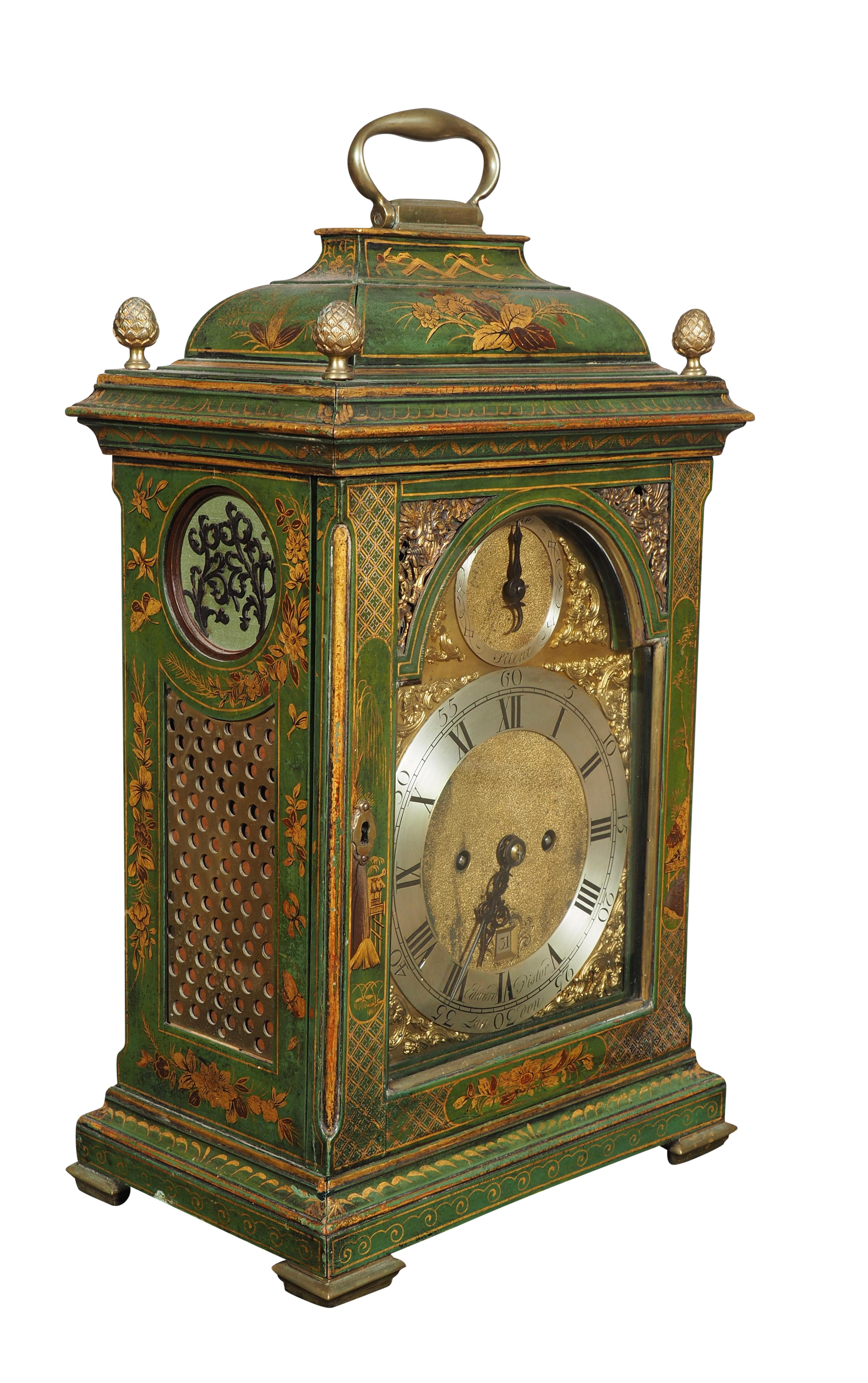 With arched top with brass carrying handle and pineapple finials over an arched glazed door enclosing the clock works by the London maker. Clock strikes on the hour with a reserved ding. Case decorated with Asian inspired decoration in a beautiful