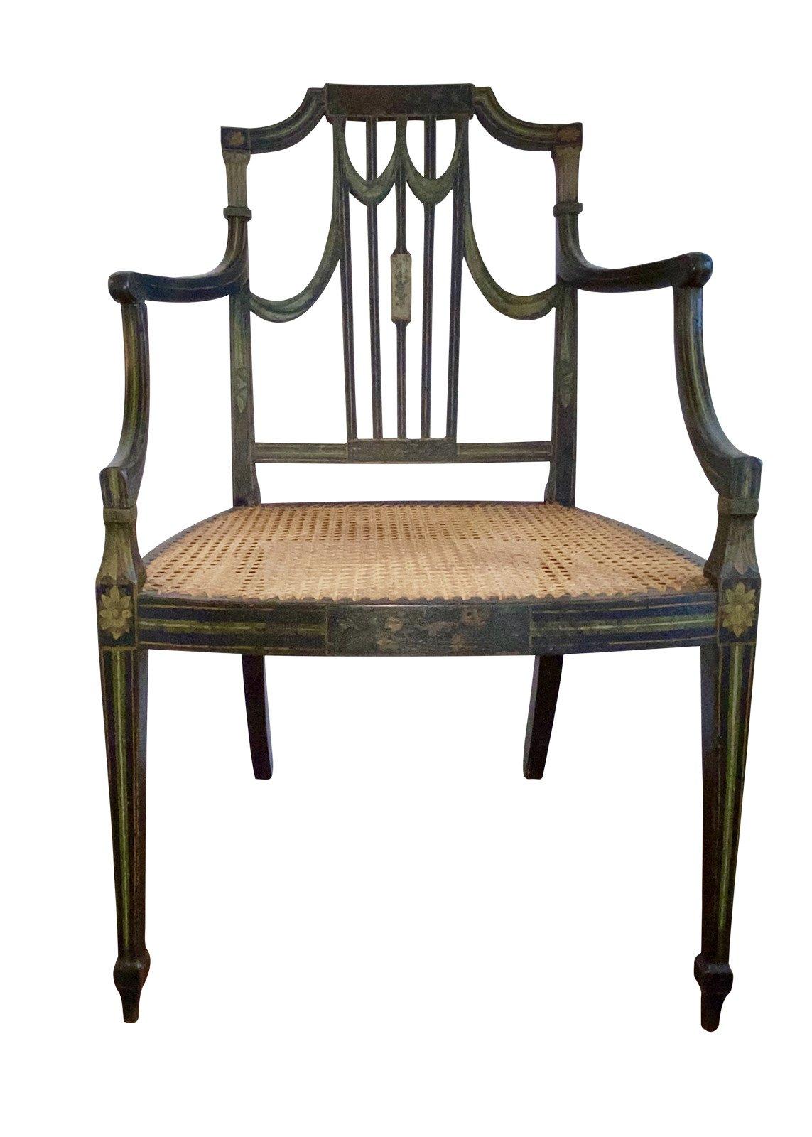 Rare George III hand painted armchair in the Sheraton Manner, 18th century. Swag form back with sweeping arms, caned seat, over square tapered legs having cuffs an pointed feet to the fore, sweeping square legs to the rare, primarly original