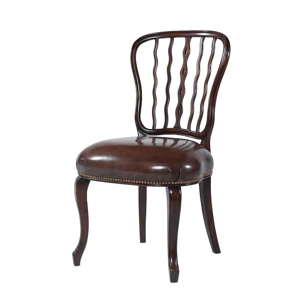 A mahogany dining chair, the shaped waisted back with serpentine uprights above an upholstered seat, on elegant molded cabriole legs terminating in spade feet. The original by George Seddon circa 1800.

Dimensions: 20.25