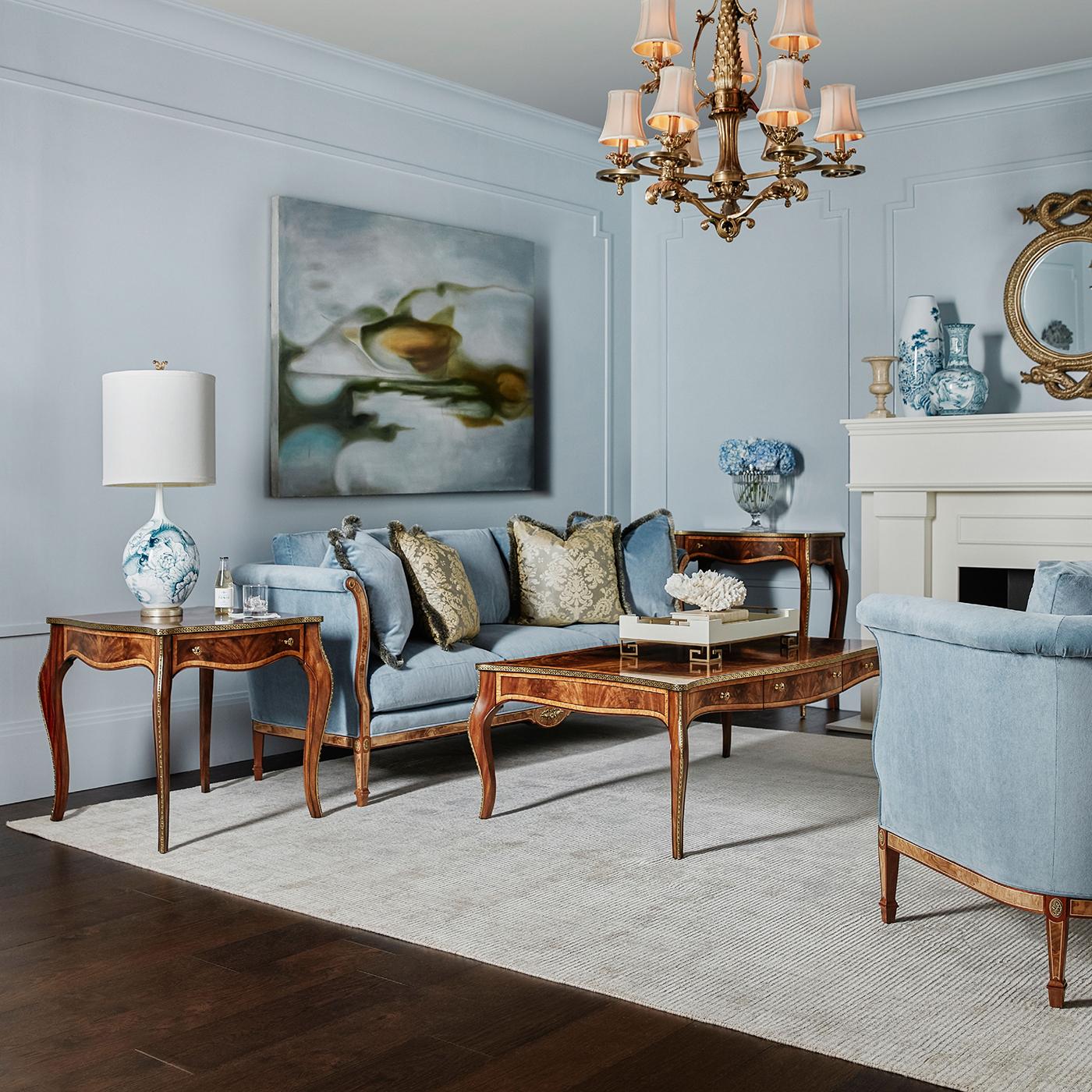 A masterpiece of craftsmanship that is sure to elevate the style and sophistication of any living space.

Made with exquisite figured wood veneers, this small table features stunning marquetry woodworking and banding details on its top that draw the