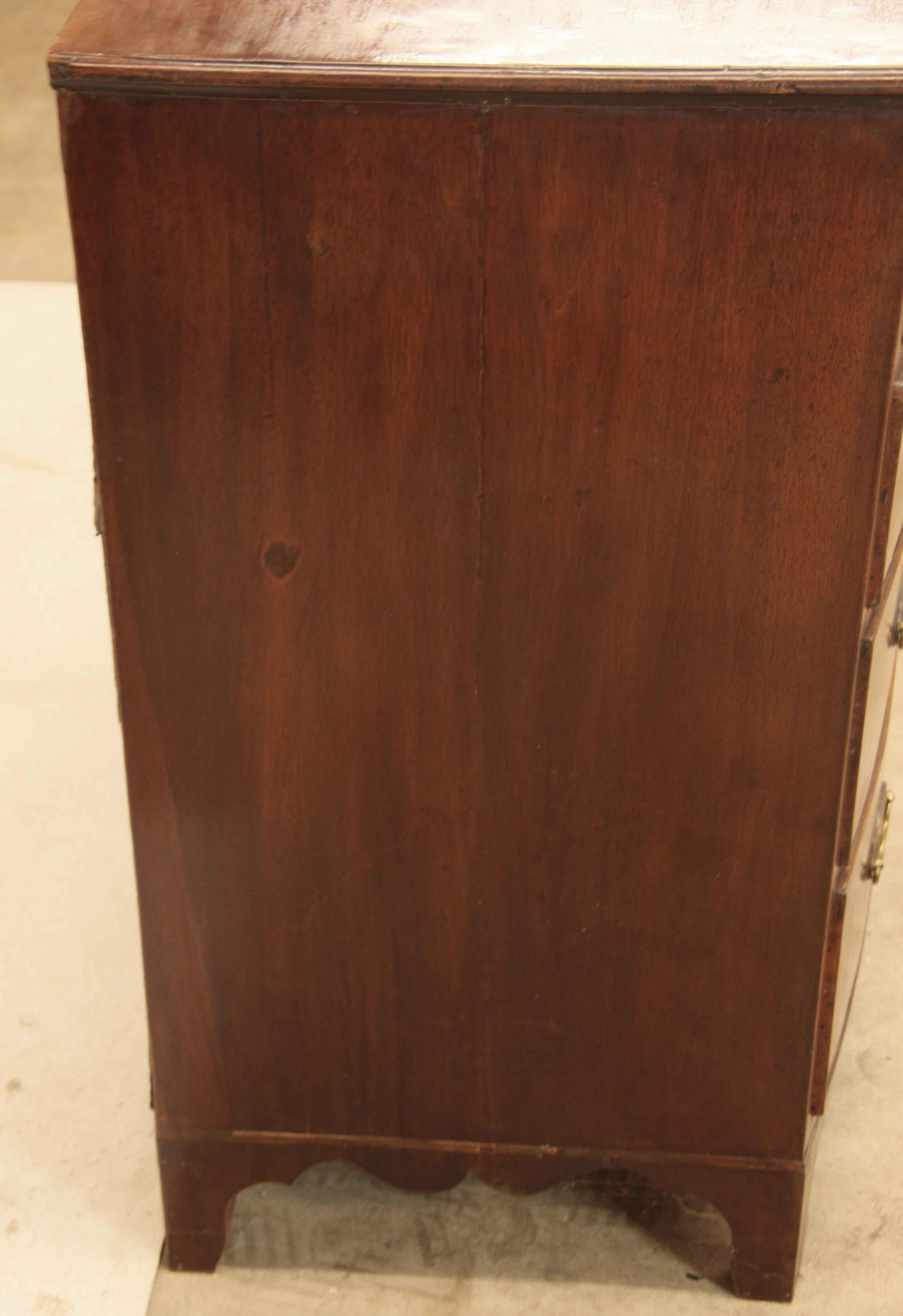 George III inlaid bow front chest , the three over three graduated drawers are inlaid with boxwood with pine secondary wood, the oval brass pulls are not original;  the apron on the sides and front have beautiful serpentine shapes.  This chest has