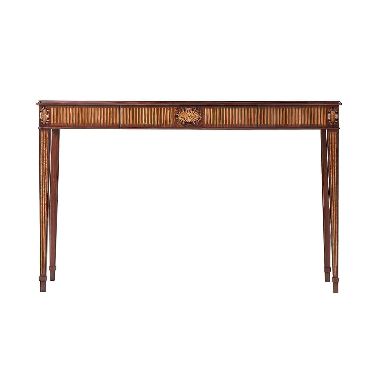 A George III style flame mahogany and parquetry veneered console table, the serpentine molded edge top crossbanded in Morado and fine stringing, with a central fan motif, above a veneered fluted veneered apron and fan inlaid details with a central