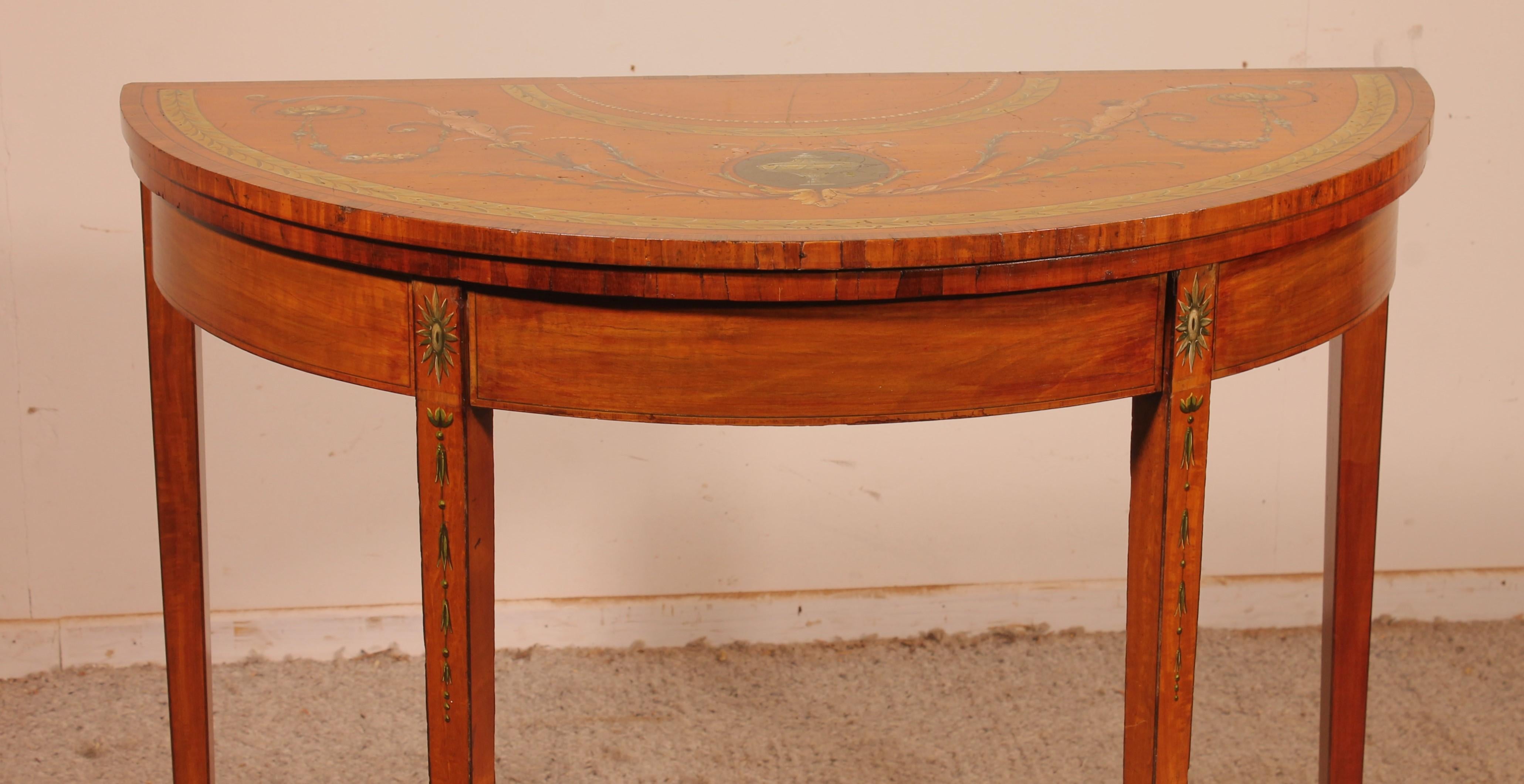 Elegant console or card table in satinwood and hand painted circa 1790 from Ireland.

Indeed, the satin and polychrome consoles are very often Irish. In addition, the top shelf is slightly advanced in order to lift it easily. This is typical from