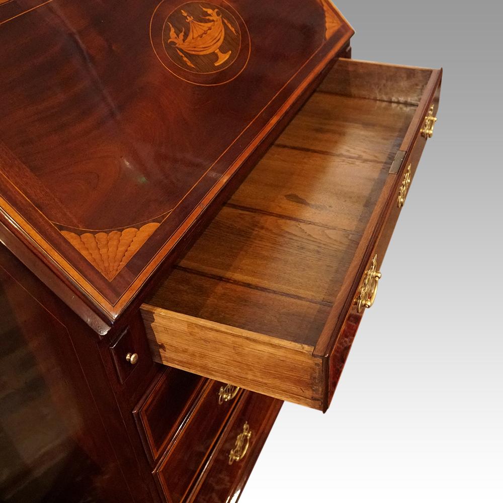 George III inlaid mahogany bureau
This George III inlaid mahogany bureau was made circa 1780.
It has the unusual drawer formation of a wide drawer at the top, a pair of small drawers under and then a further 2 wide graduated drawers below. The