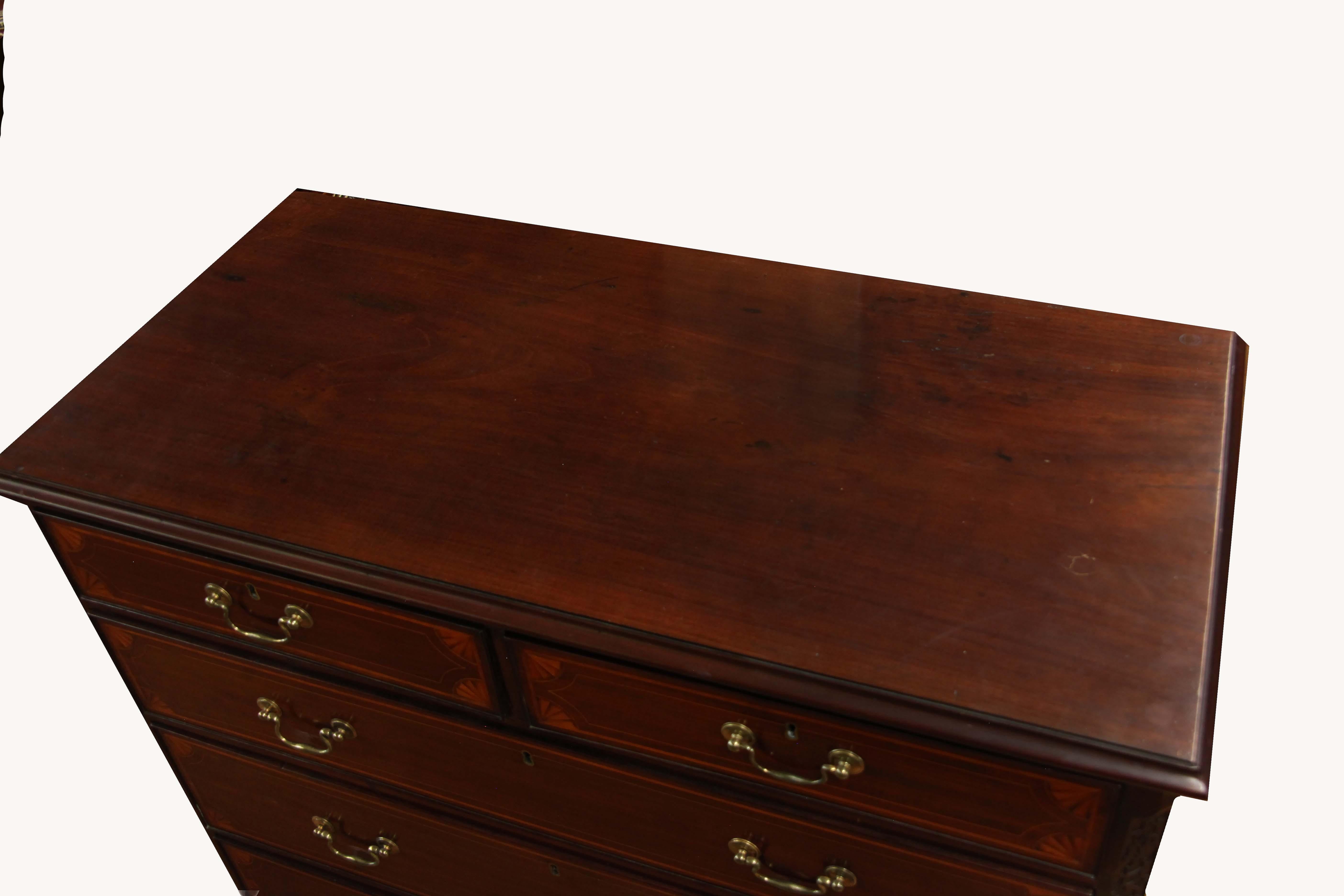 George III inlaid mahogany chest with blind fretwork chamfered corners. The drawers have inlaid quarter fans and boxwood line inlay. The hardware is original.