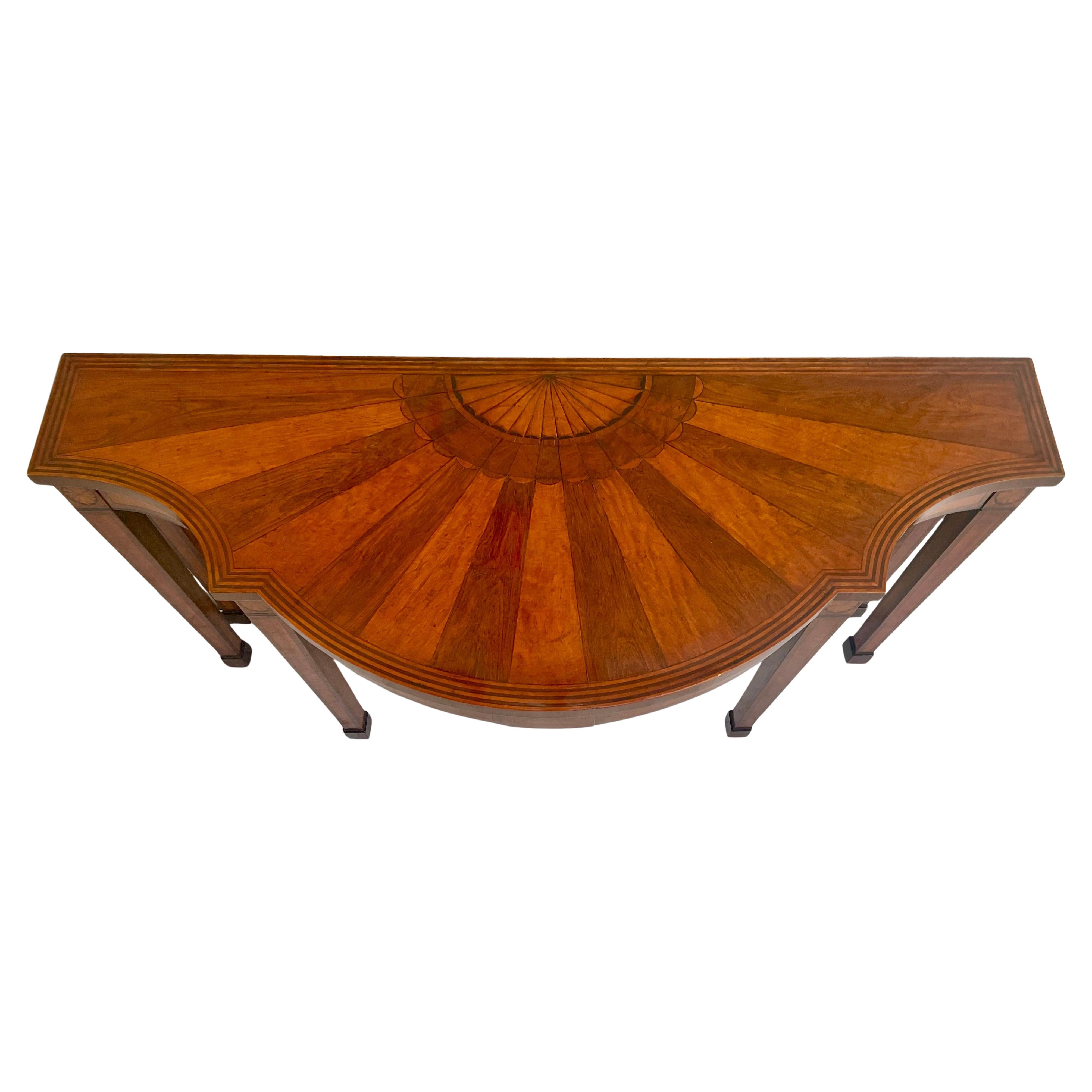 George III Inlaid Mahogany and Satinwood Banded Demi-Lune Console / Serving Table. The serpentine-form top features an elegant two-tone sunburst inlay at center, framed by crossbanded borders and fine inlays. Raised on six square tapered legs with