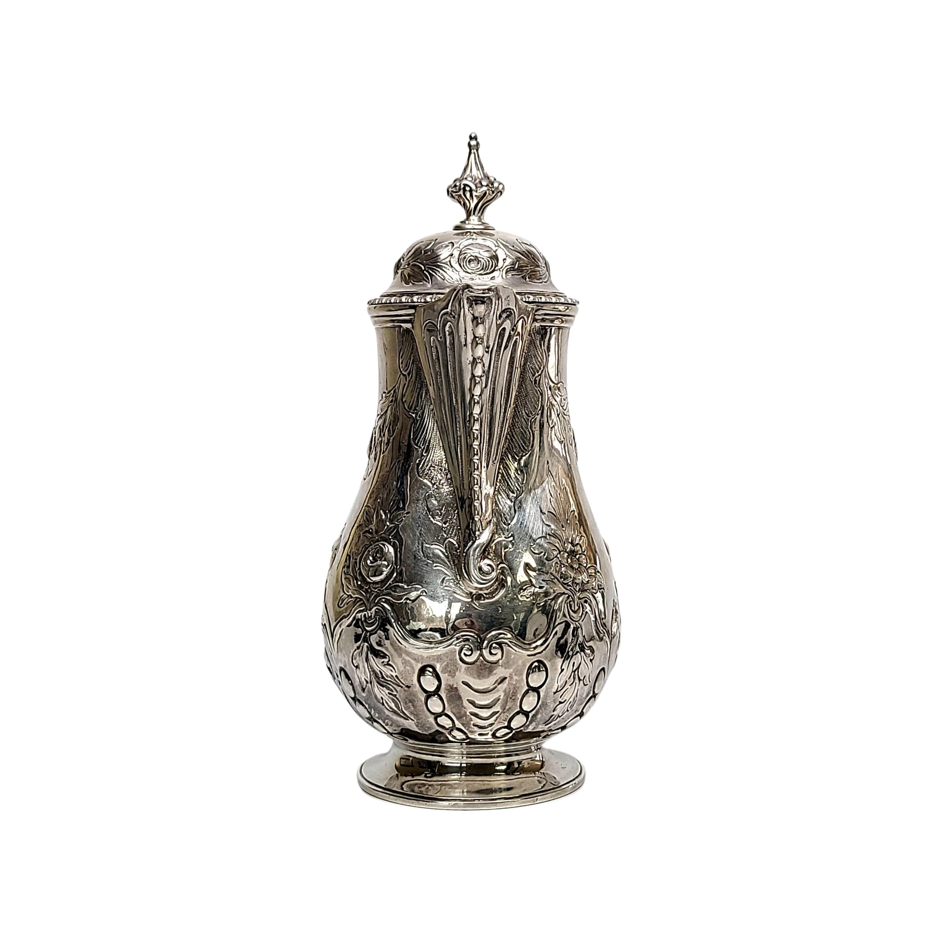 George III era sterling silver hot milk jug by Jon King of London, England, circa 1776.

Beautiful and elegant oval baluster form on a domed foot featuring a hinged lid with finial lid topper, scroll design black wood handle and beaded edge beak
