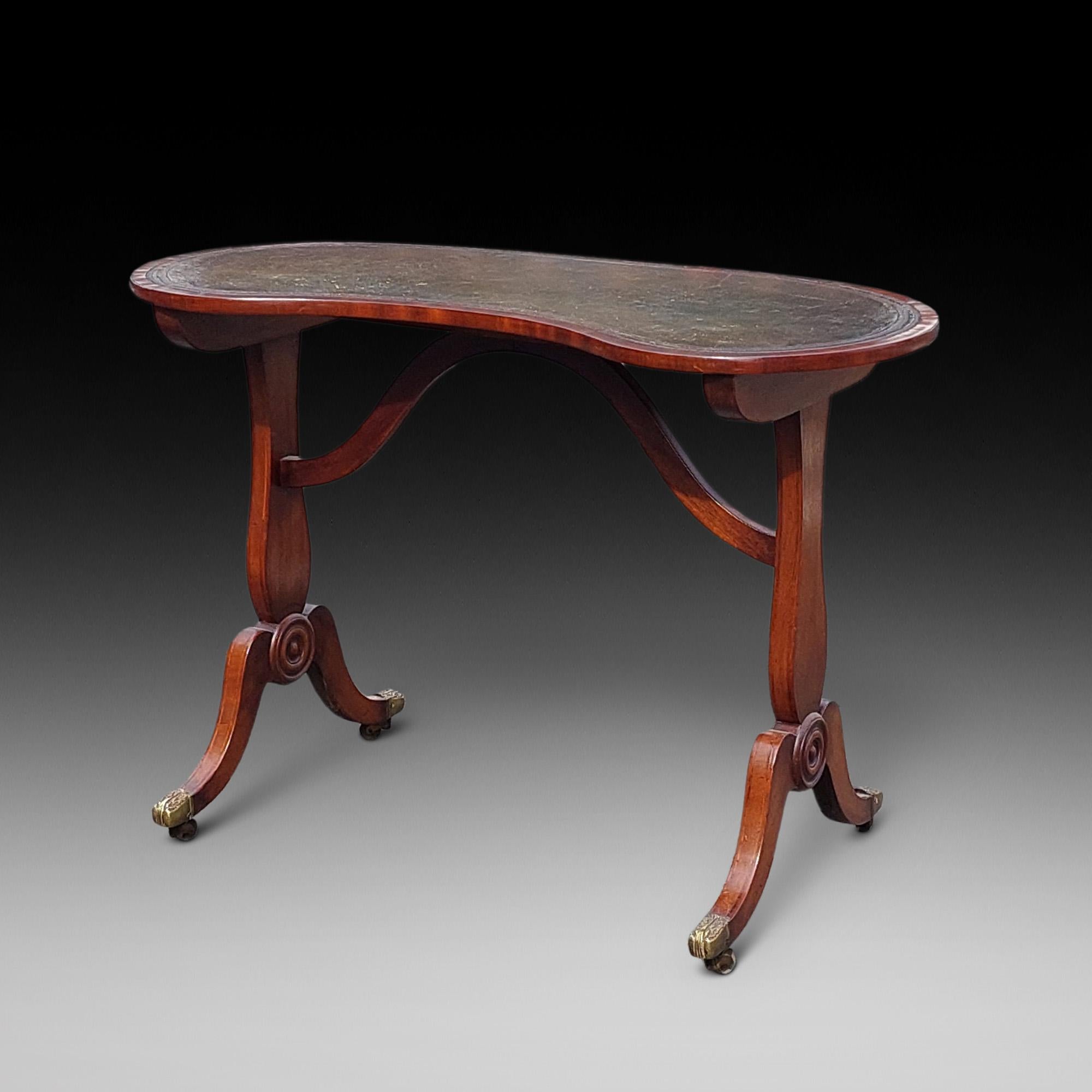 George III Kidney Shaped Open Writing Table with High Stretcher between End Supports on Sabre Legs and Brass Castors 40