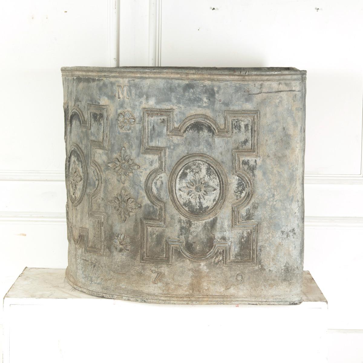 George III corner lead cistern, initialled M and dated 1779.

Cisterns were widely produced in 17th and 18th Century Britain and were used for storing rainwater, to be used in the home and the garden. Both decorative and practical, they were a