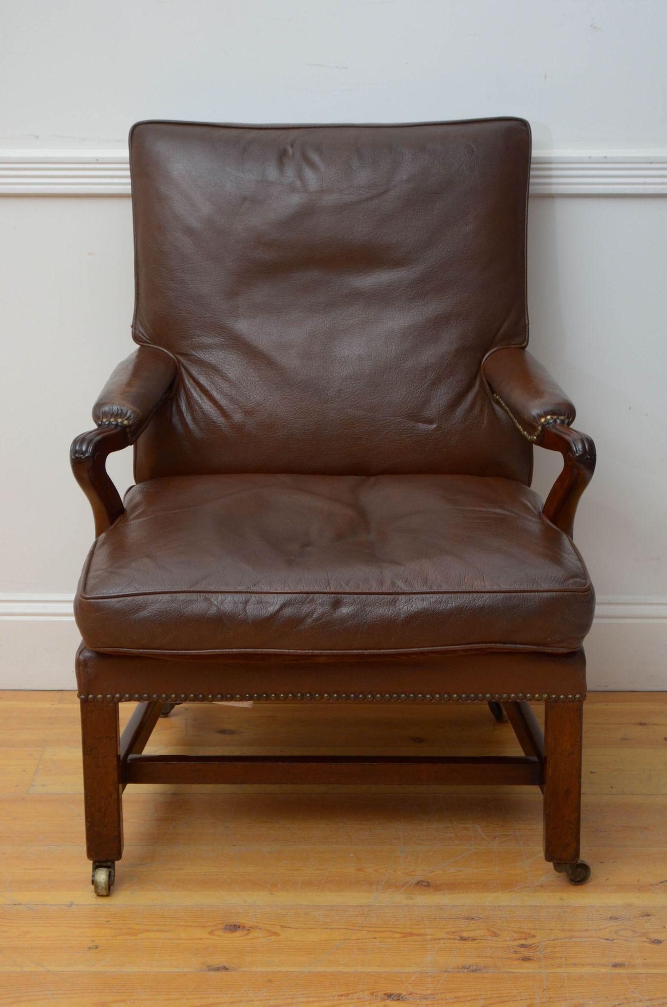 Sn5515 Superb Georgian library chair or club chair, having brown leather upholstered back, generous leather seat and open, reeded and leather padded arms with closely studded edge, all standing on simple square legs united by stretchers. This