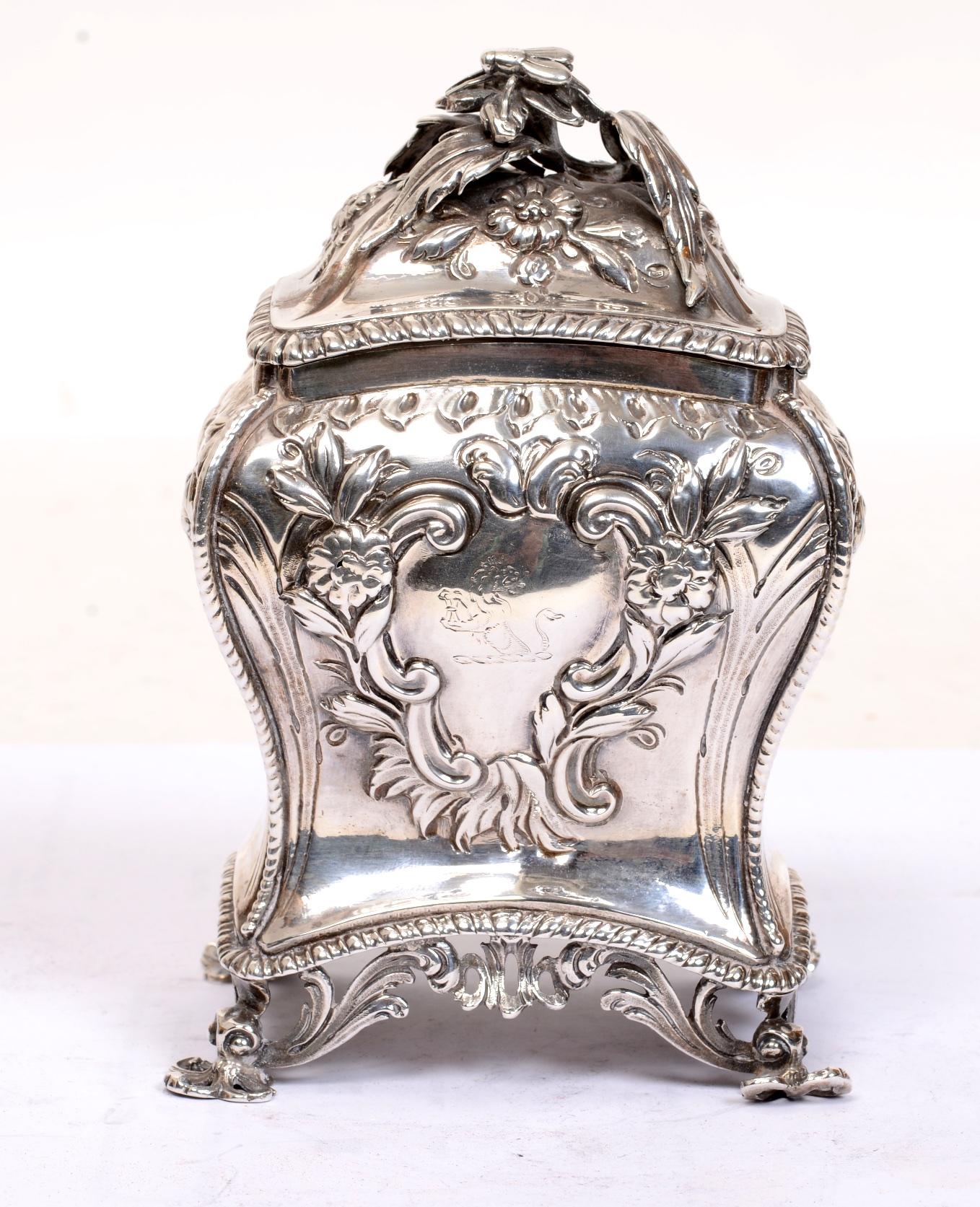 George III London sterling silver tea caddy by Samuel Herbert & Co, circa 1766. Rectangular bombé form with domed cover. The top and sides embossed with repousse flower heads. The hinged top has a floral finial with a stylized bee perched on the
