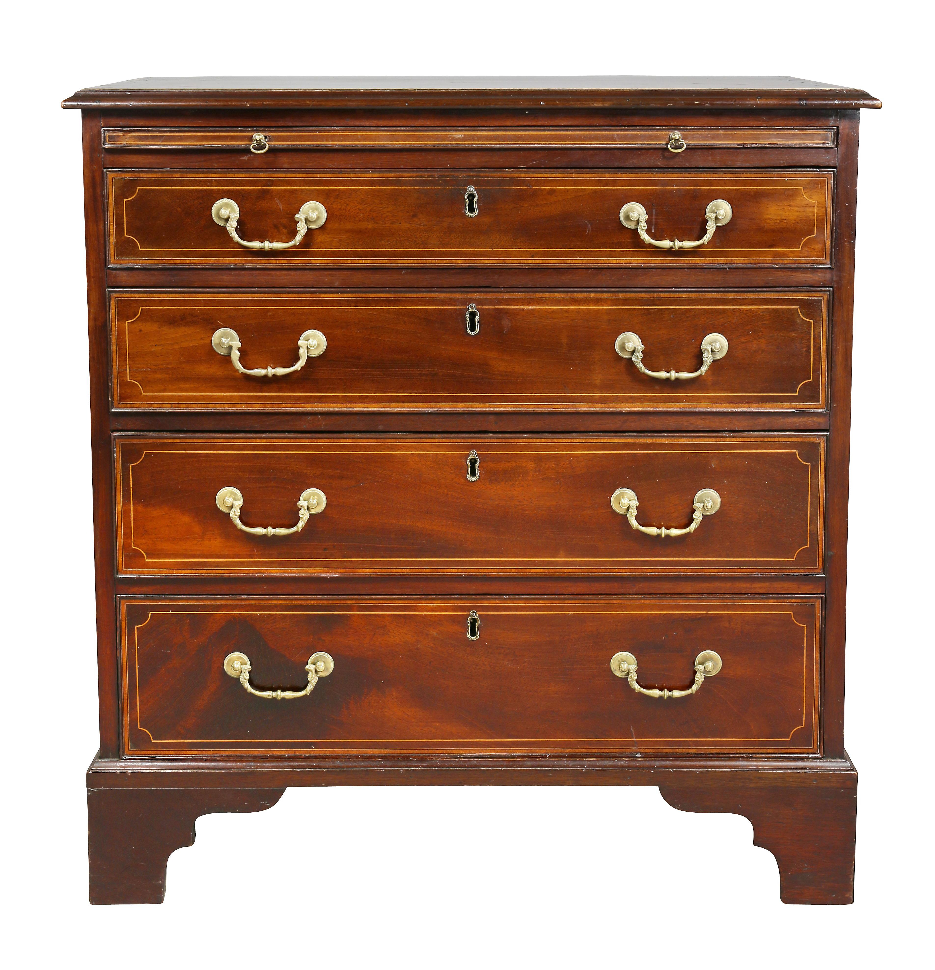With rectangular top with banded edge over a brushing slide and four graduated drawers, bracket feet.