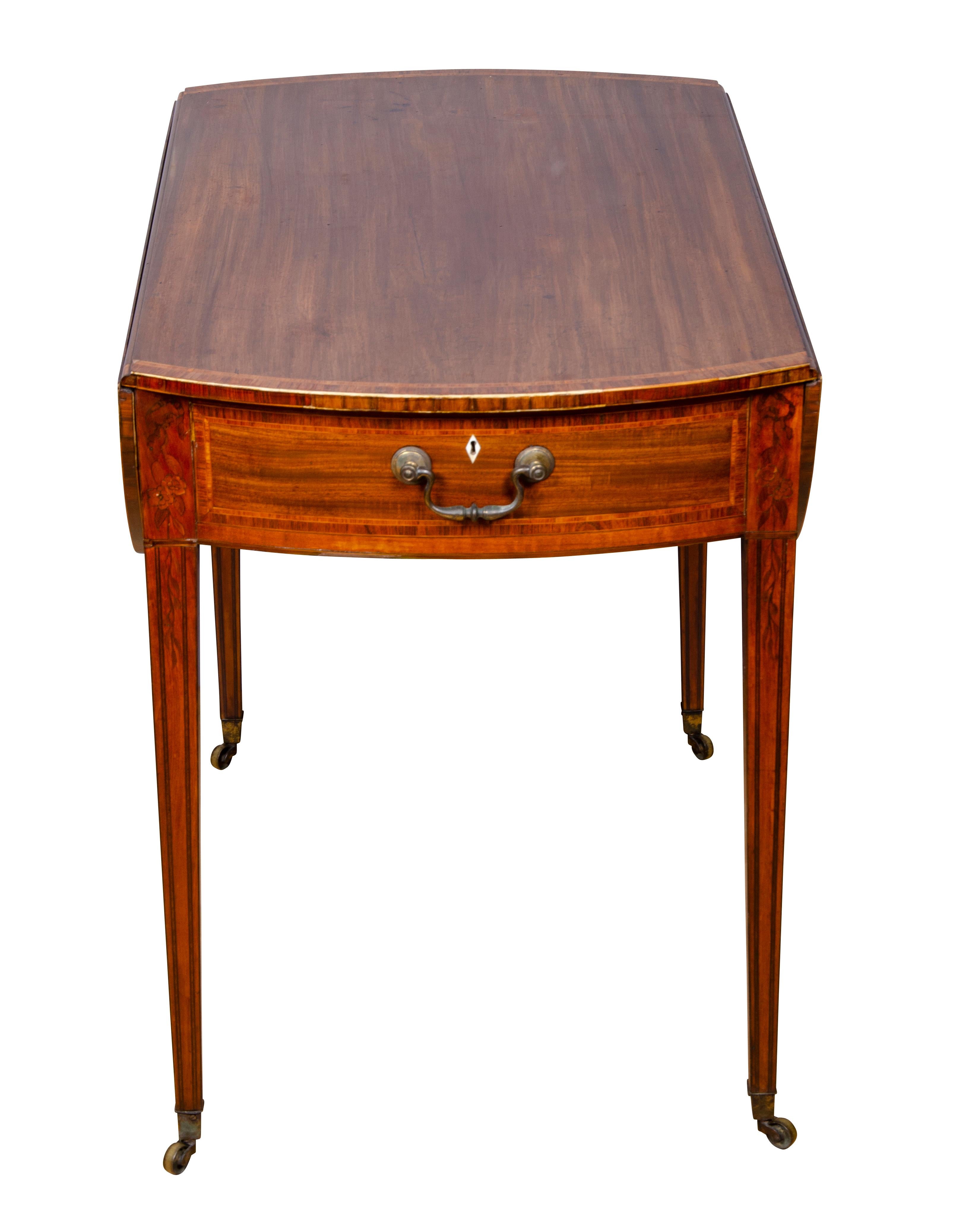 Fine quality example, rectangular form with D- shaped drop leaves, frieze drawer with handle, raised on square tapered legs. Casters. Floral inlays and string, cross banding throughout.