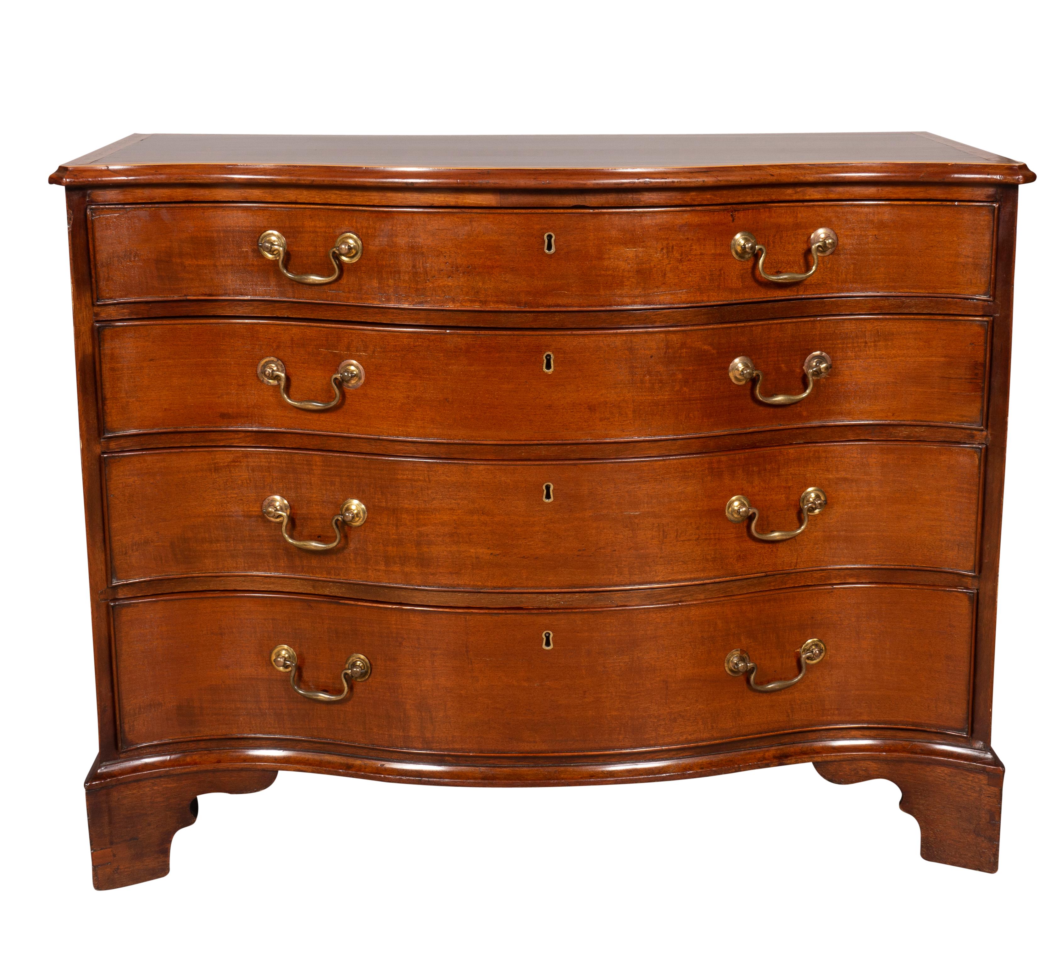 Serpentine top with satinwood banding with etched floral decoration over a conforming frieze with four graduated drawers , raised on bracket feet. Brass bail handles.