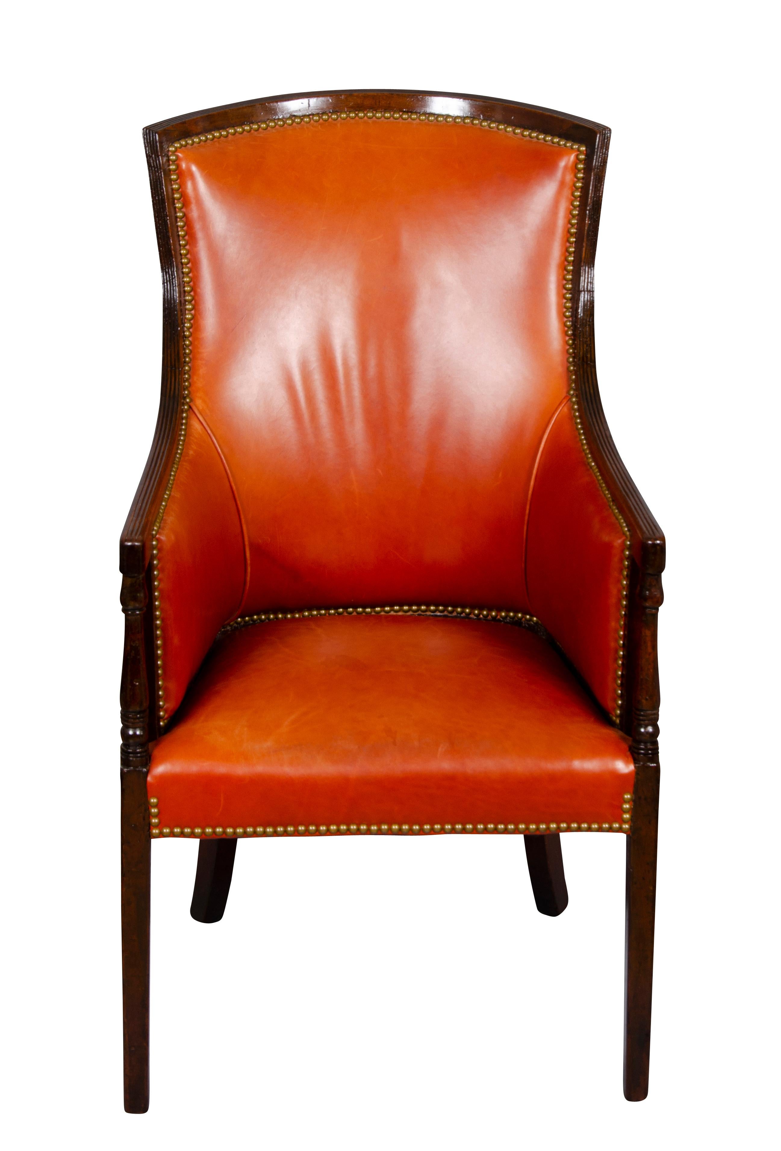 With nice tacked red leather with curved back, downswept arms raised on square tapered legs.