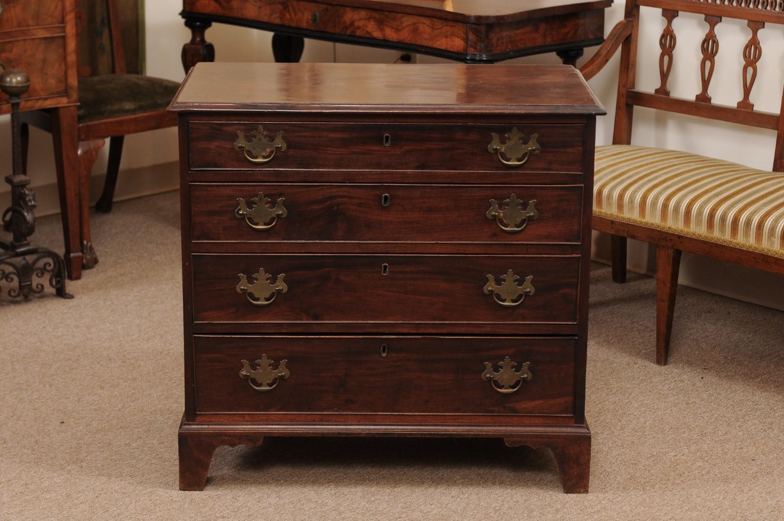 The George III mahogany bachelors chest with rectangular top and moulded edge above 4 drawers with brass pulls and backplate. All resting on carved bracket feet.