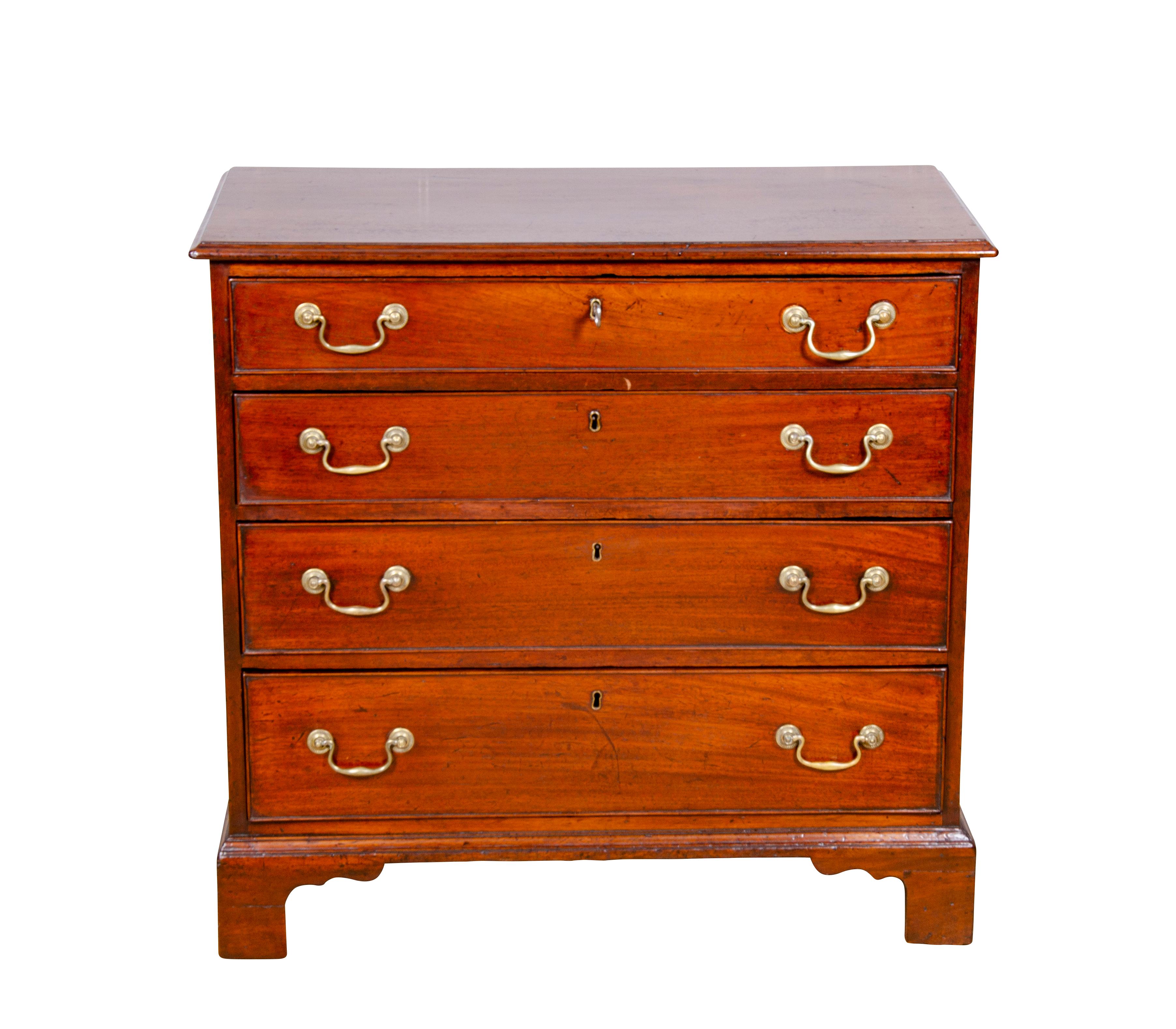 Rectangular top with molded edge over four graduated drawers with brass bail handles raised on bracket feet.