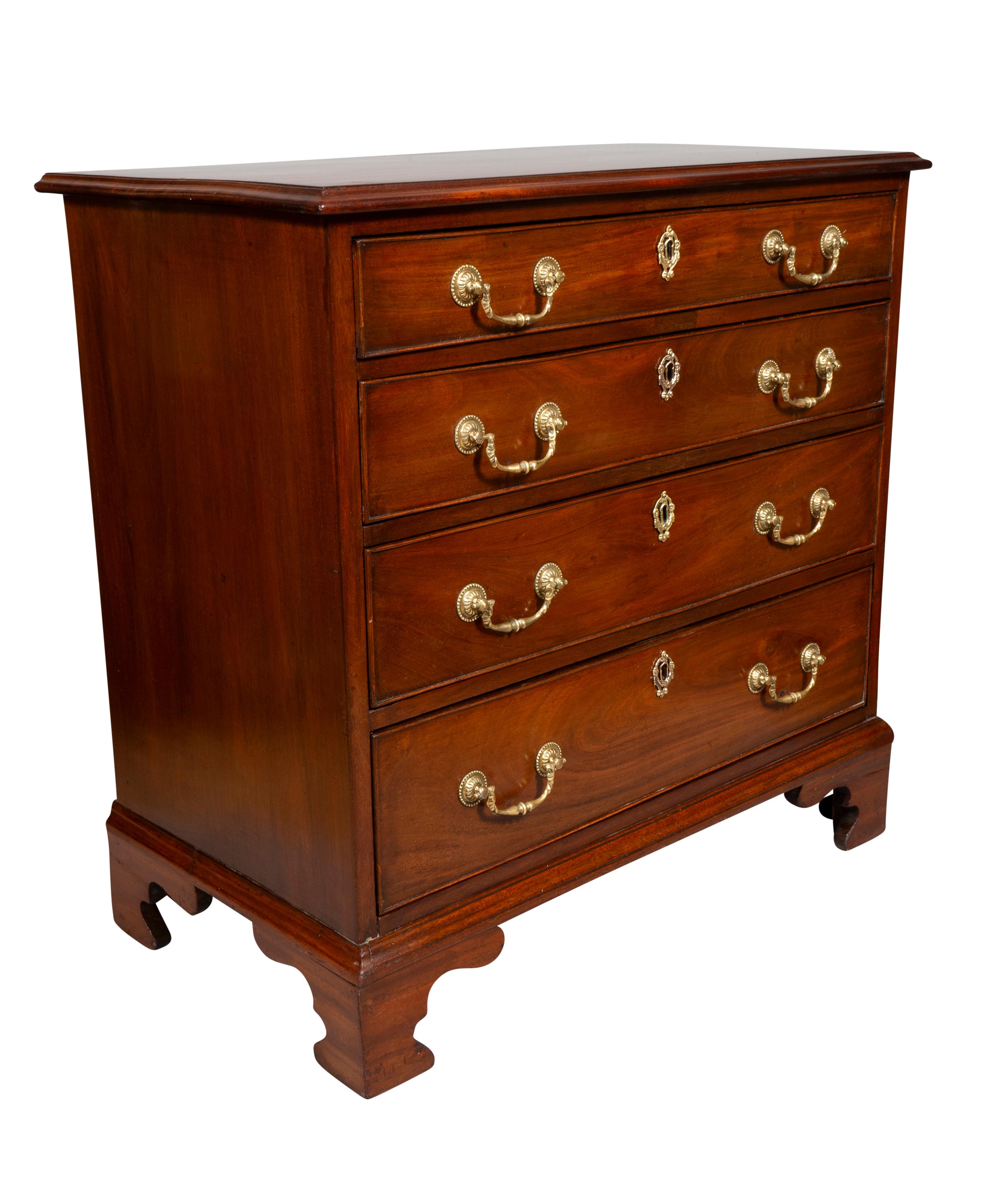 Rectangular top over four graduated drawers with bail handles.Bracket feet.