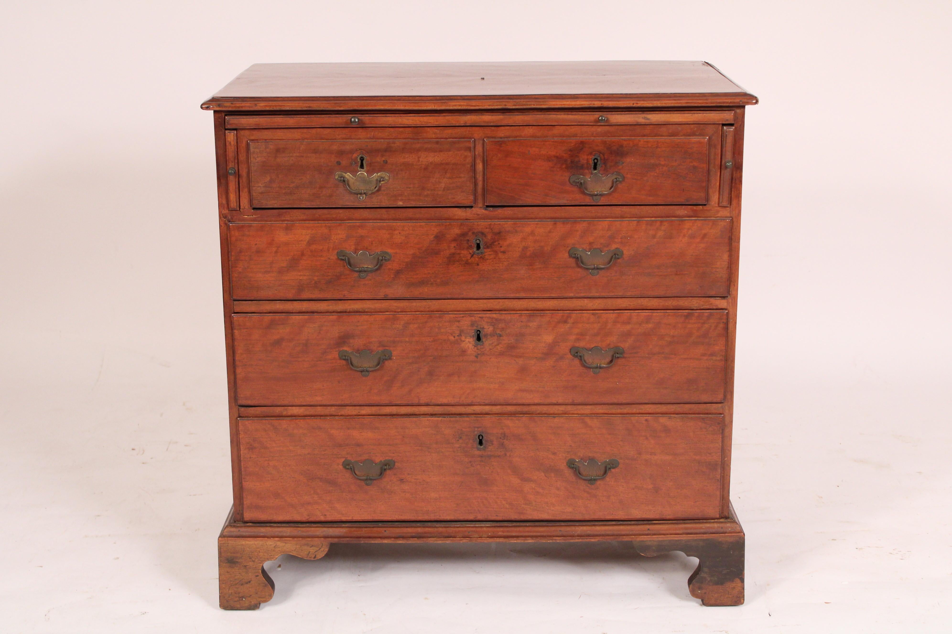 George III mahogany bachelors chest, late 18th century, With a plum pudding mahogany two board top with thumb molded front and side edges, a pull out brushing slide with two pull out supports on either side, two plum pudding mahogany top drawers and