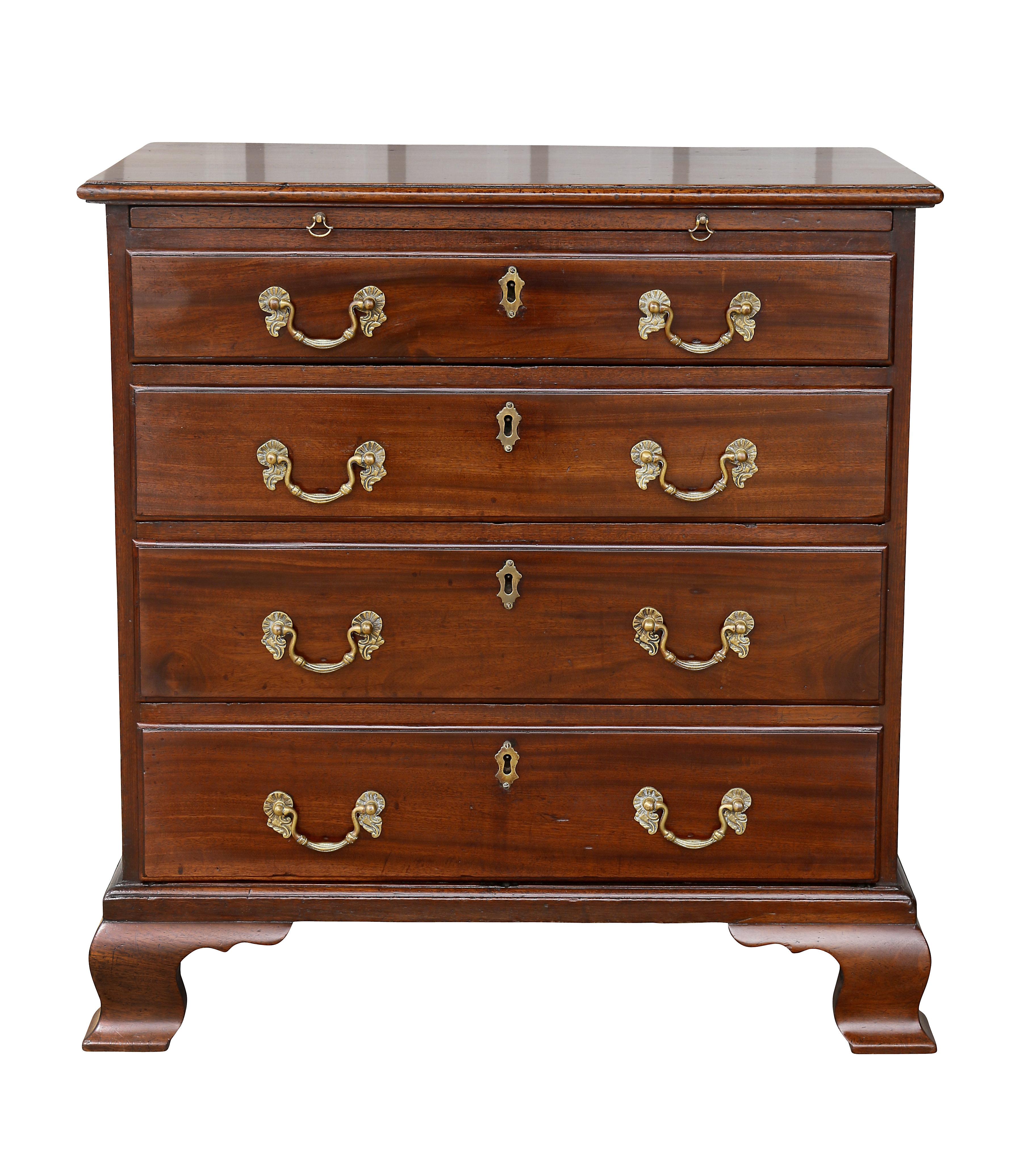 With a rectangular top over a brushing slide and four graduated drawers raised on ogee bracket feet.