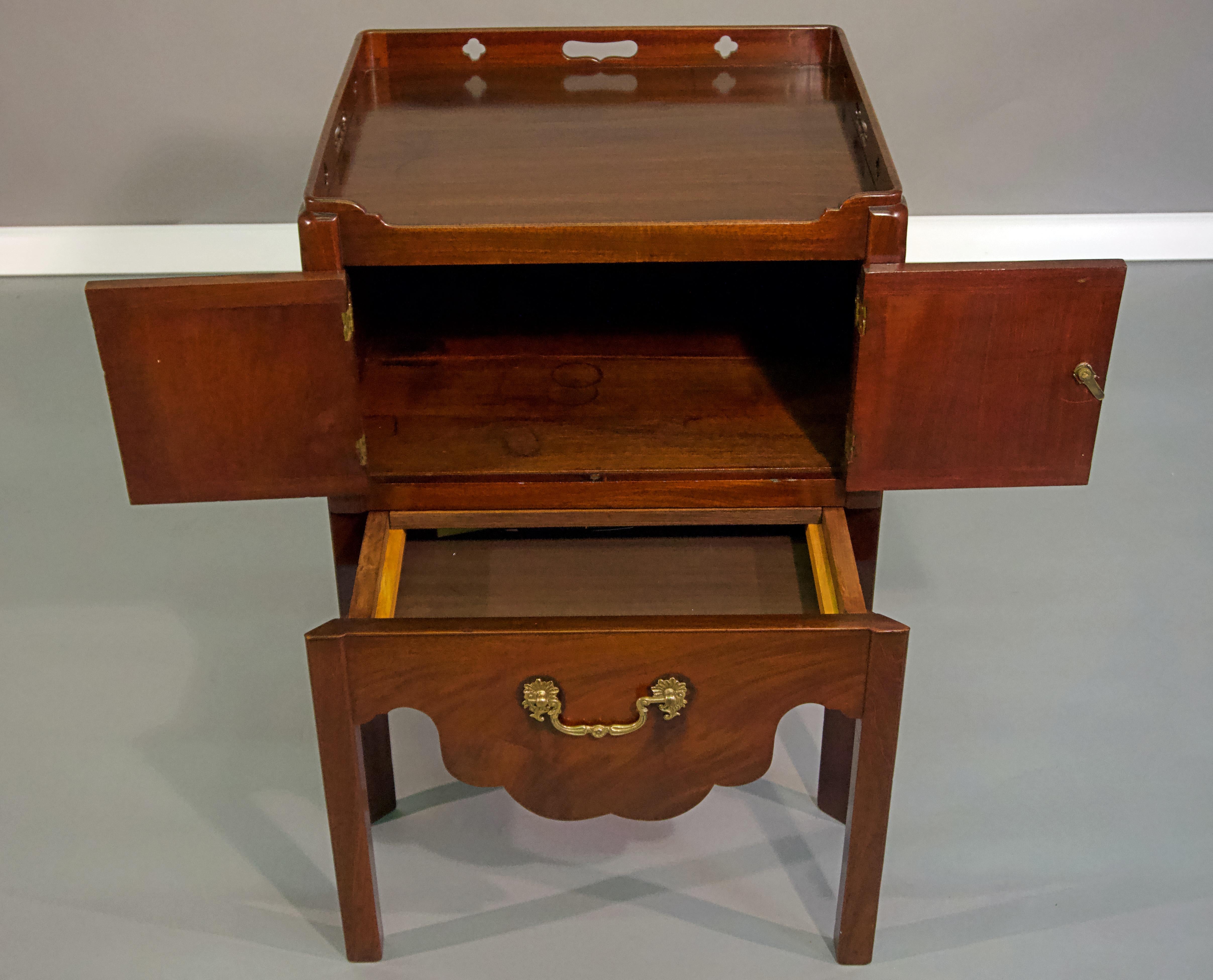 George III mahogany bedside cabinet with brass accents.