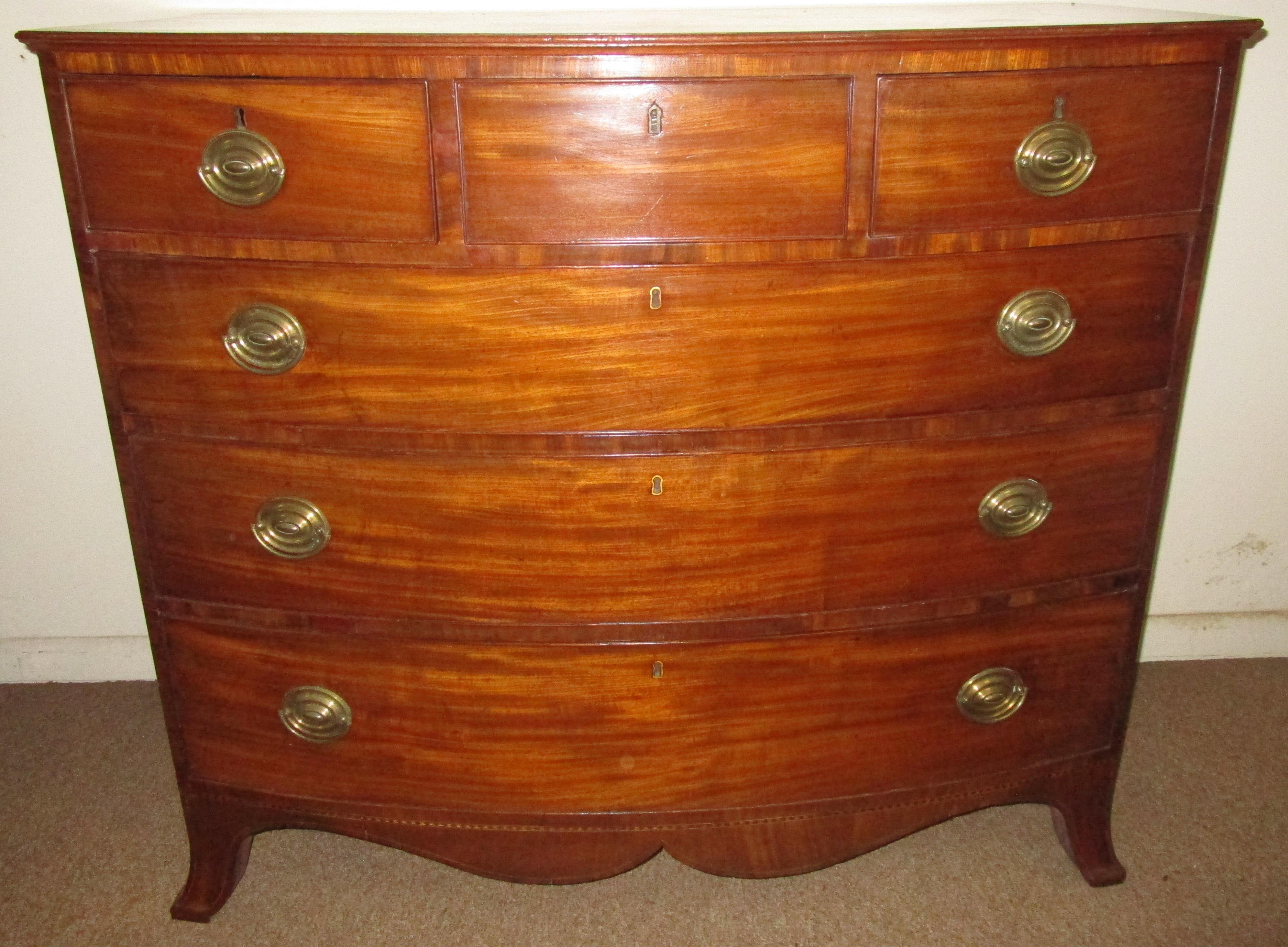 This handsome substantial sized Georgian mahogany bow front chest of drawers exhibits exceptional color and grain, with fine and accommodating proportions. Features include three short drawers, above three tiers of full width drawers, all fitted