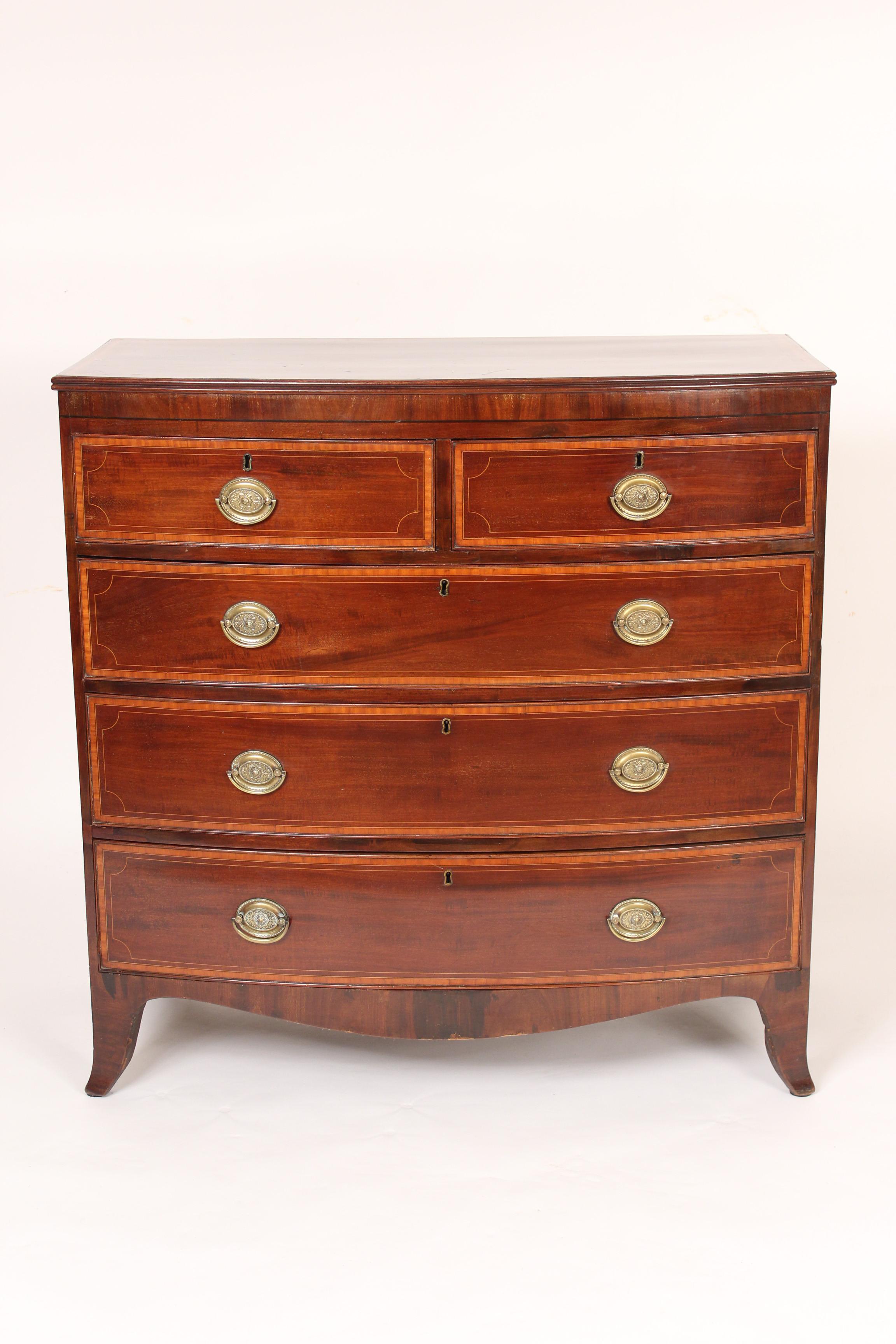 George III mahogany cross banded bow front chest of drawers, circa 1810. With satinwood cross banding on the top and drawer fronts.