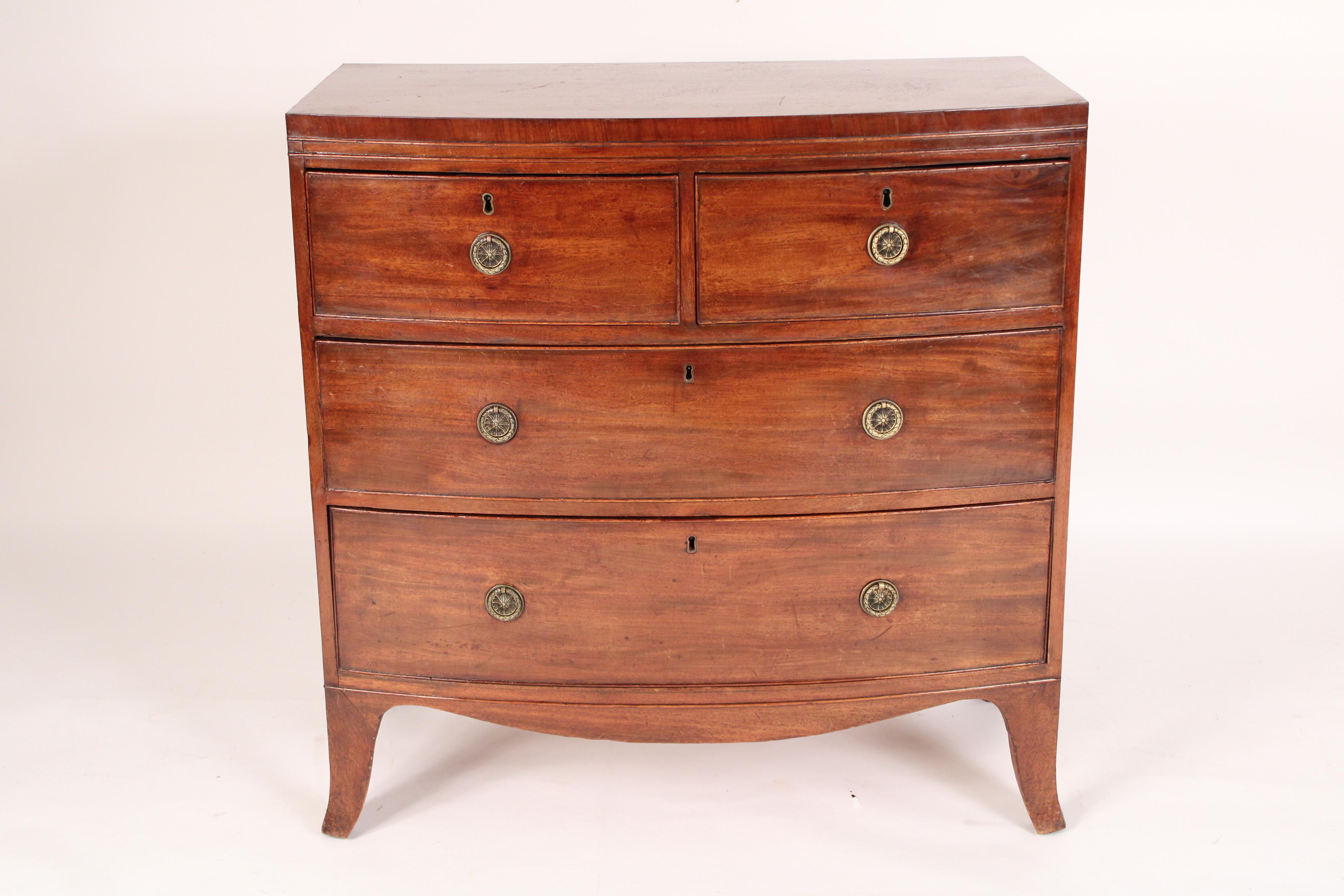 George III Mahogany and elm bow front chest of drawers, circa 1800. With two cock beaded top drawers and two cock beaded lower drawers with brass hardware, elm sides resting on splayed feet. Nice old color, dove tailed drawer construction. Measures: