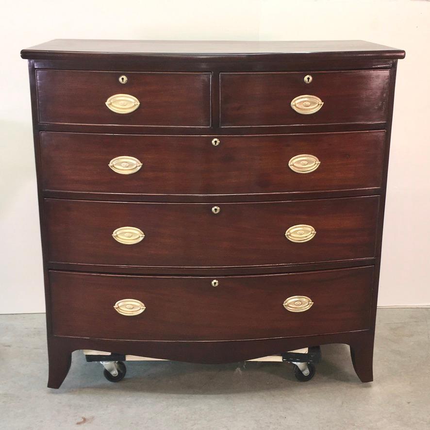 English late Georgian solid mahogany bow front chest of drawers. Two over three. Includes original keys and working locks. Ready to place.