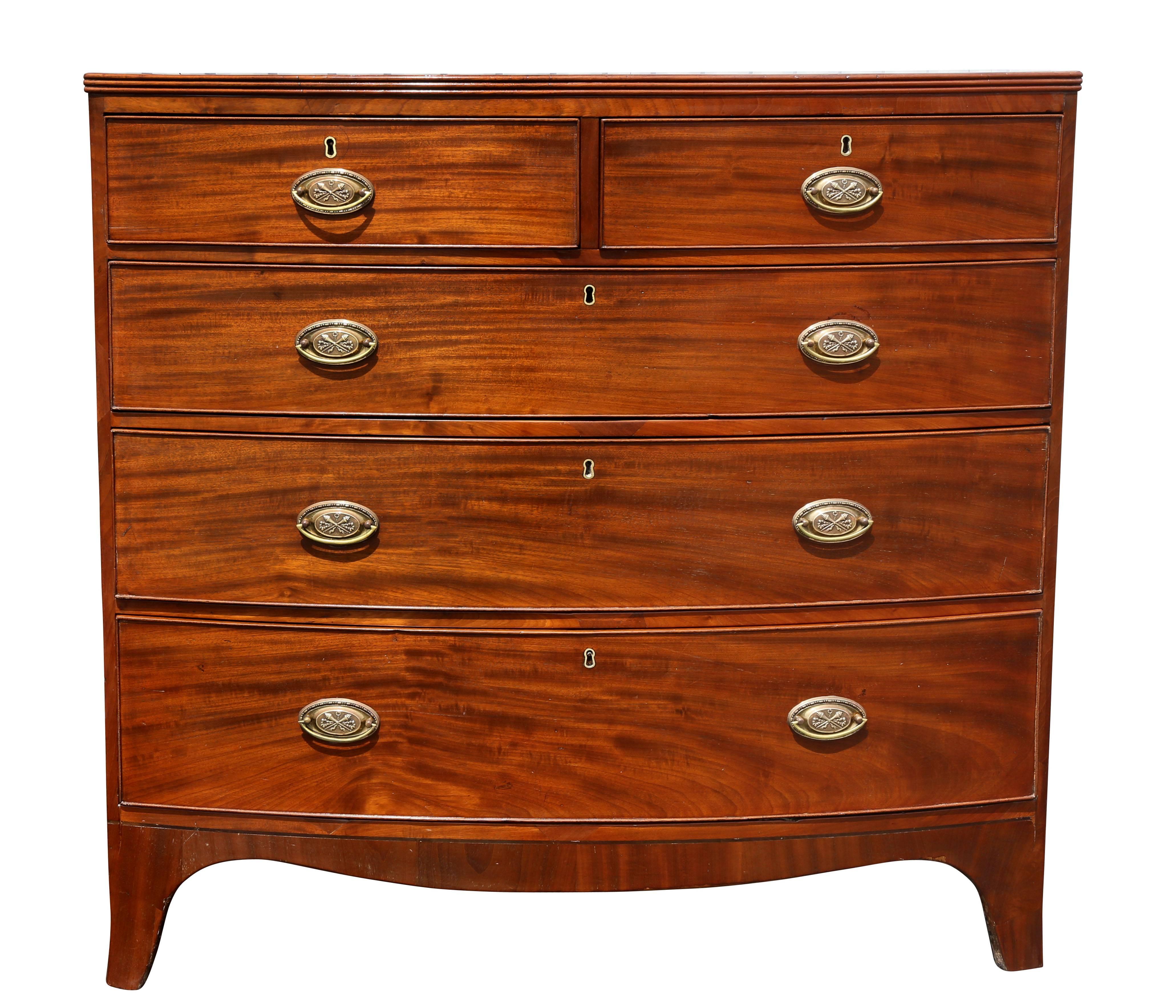 Bowed top and conforming base with two over three graduated drawers, splayed feet. Oval brass handles.